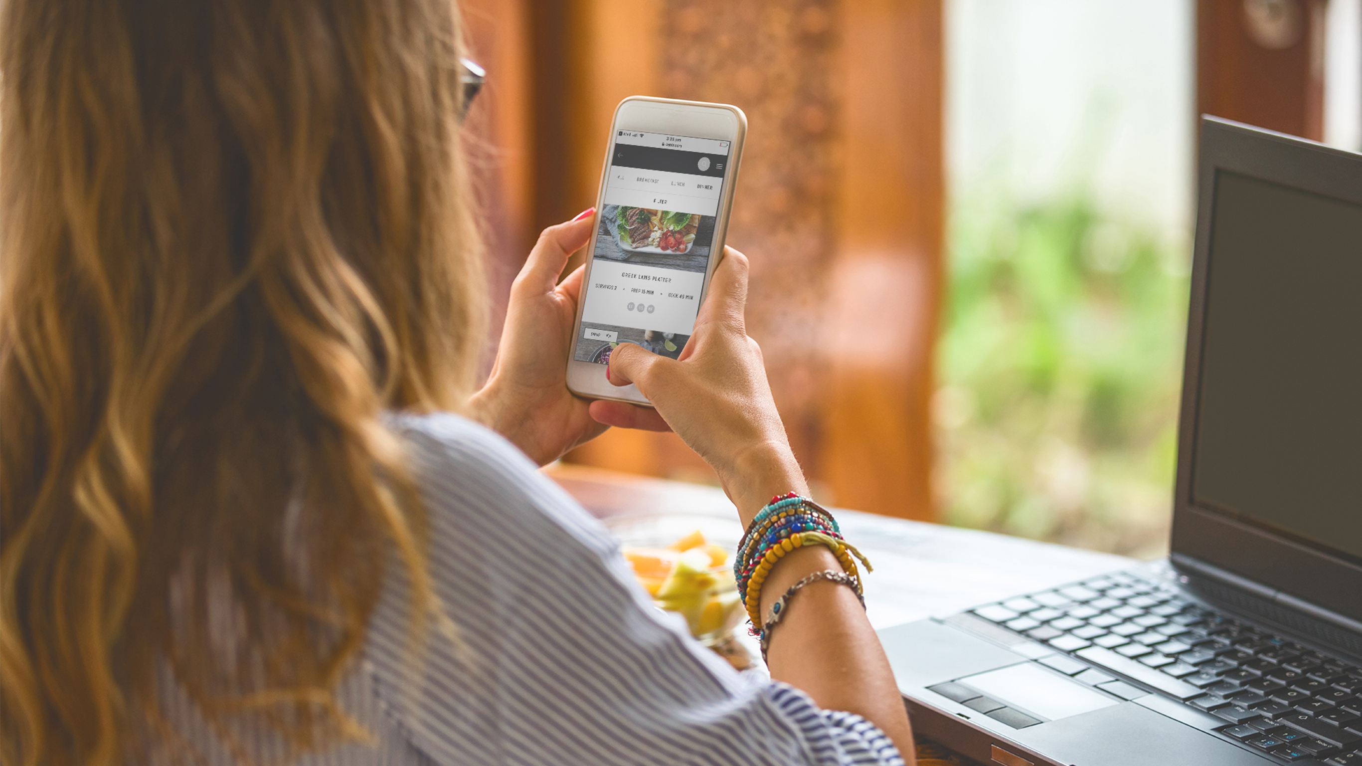 A woman uses the Centr app to plan her weekly meals.