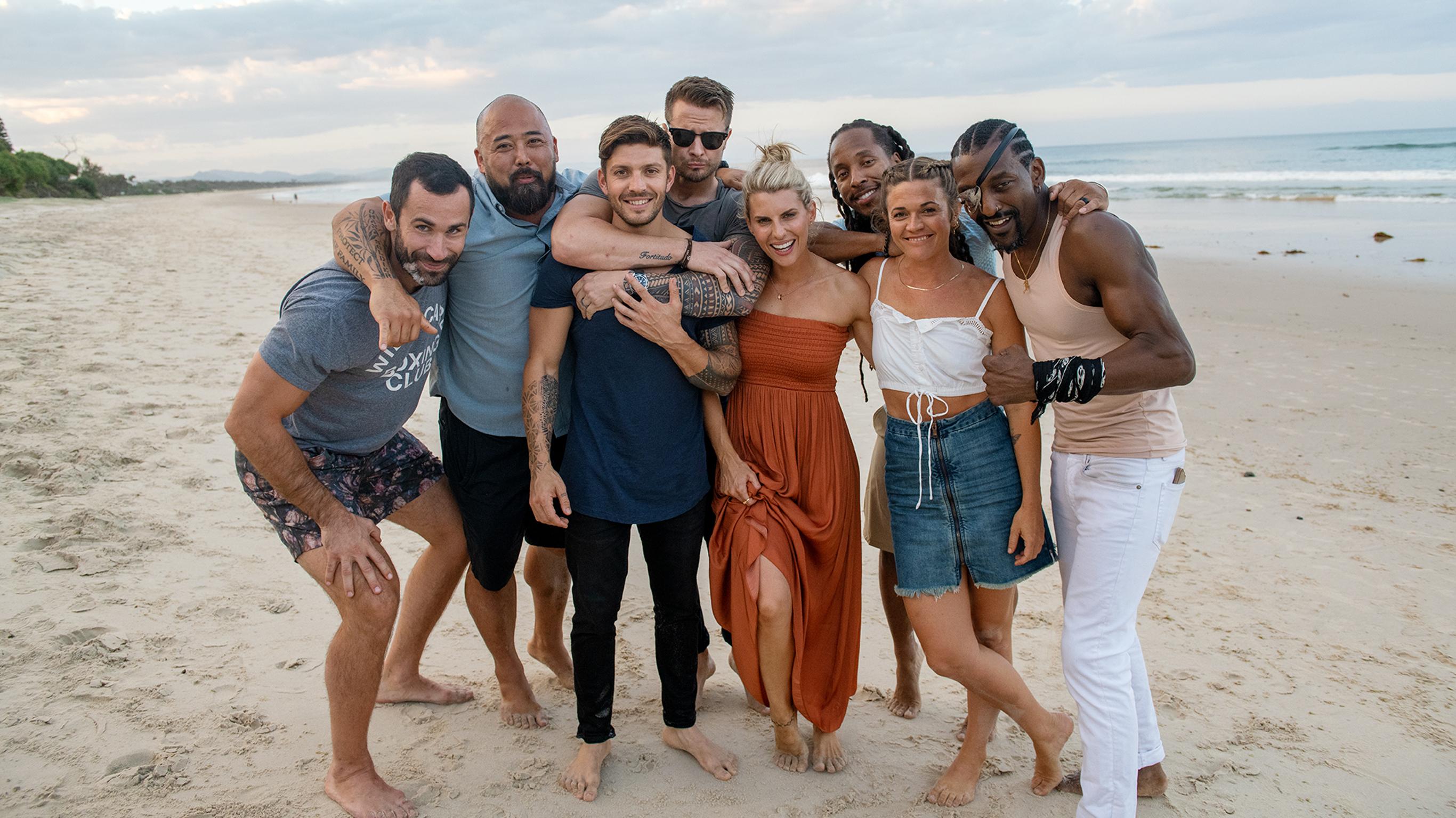 Centr's experts embrace each other on a beach in Byron Bay.