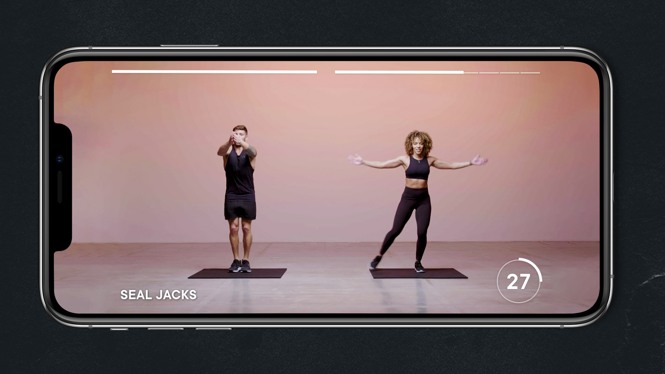 Luke Zocchi and Ashley Joi do the seal jack exercise.