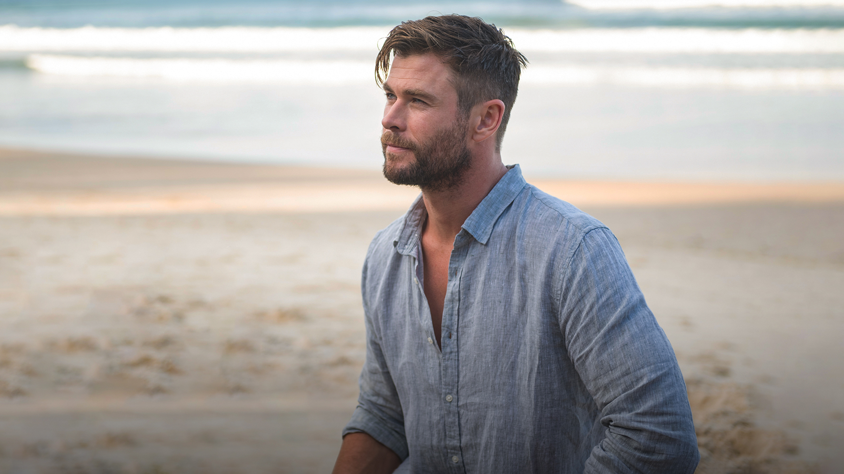 Centr founder Chris Hemsworth looks across a beach with the ocean in the background. Text overlaid on the image reads 'Learn to Meditate: Narrated by Chris Hemsworth'.