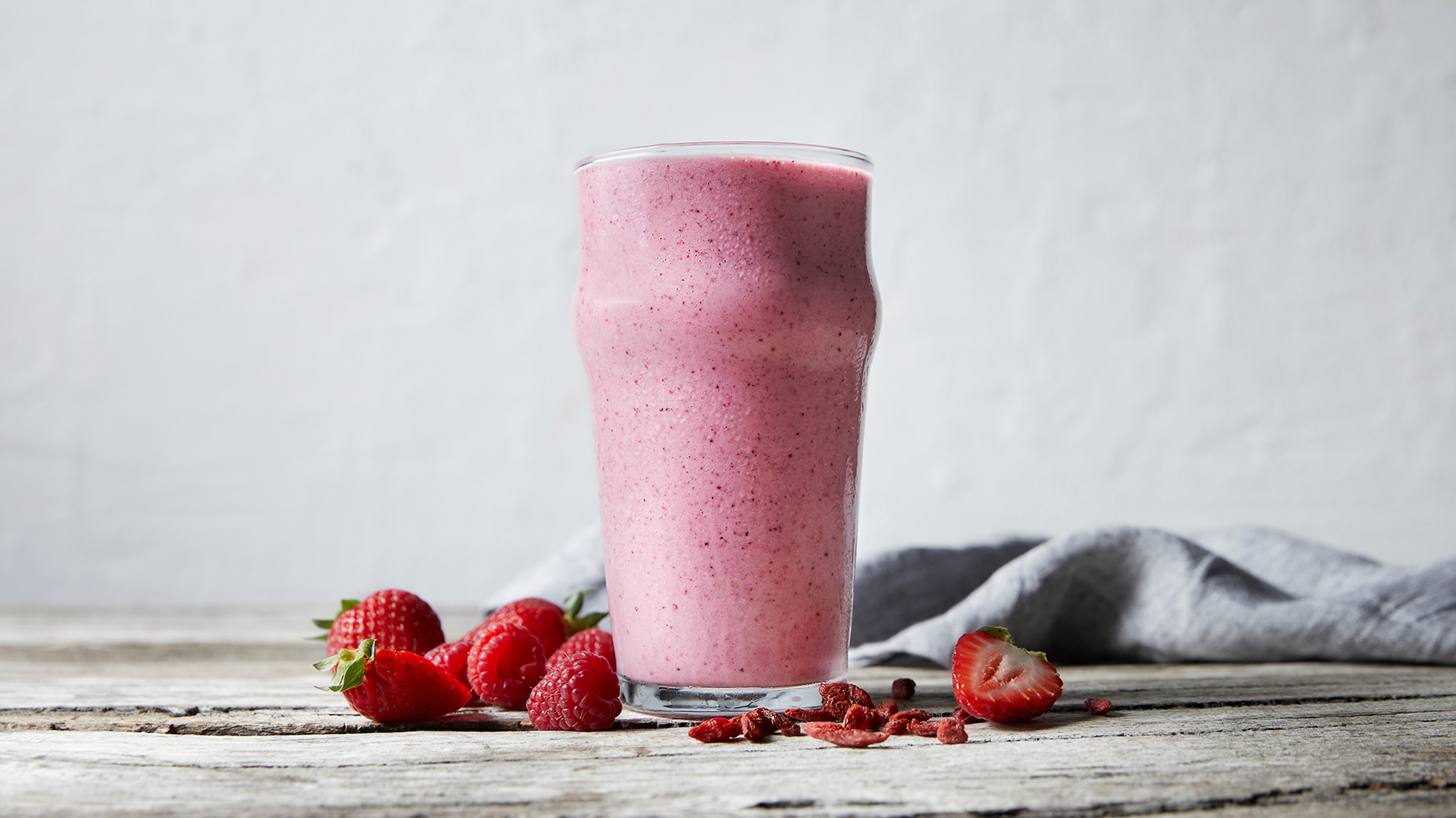 An Almond Berry Super Smoothie from the Centr meal plan, served with fresh berries.