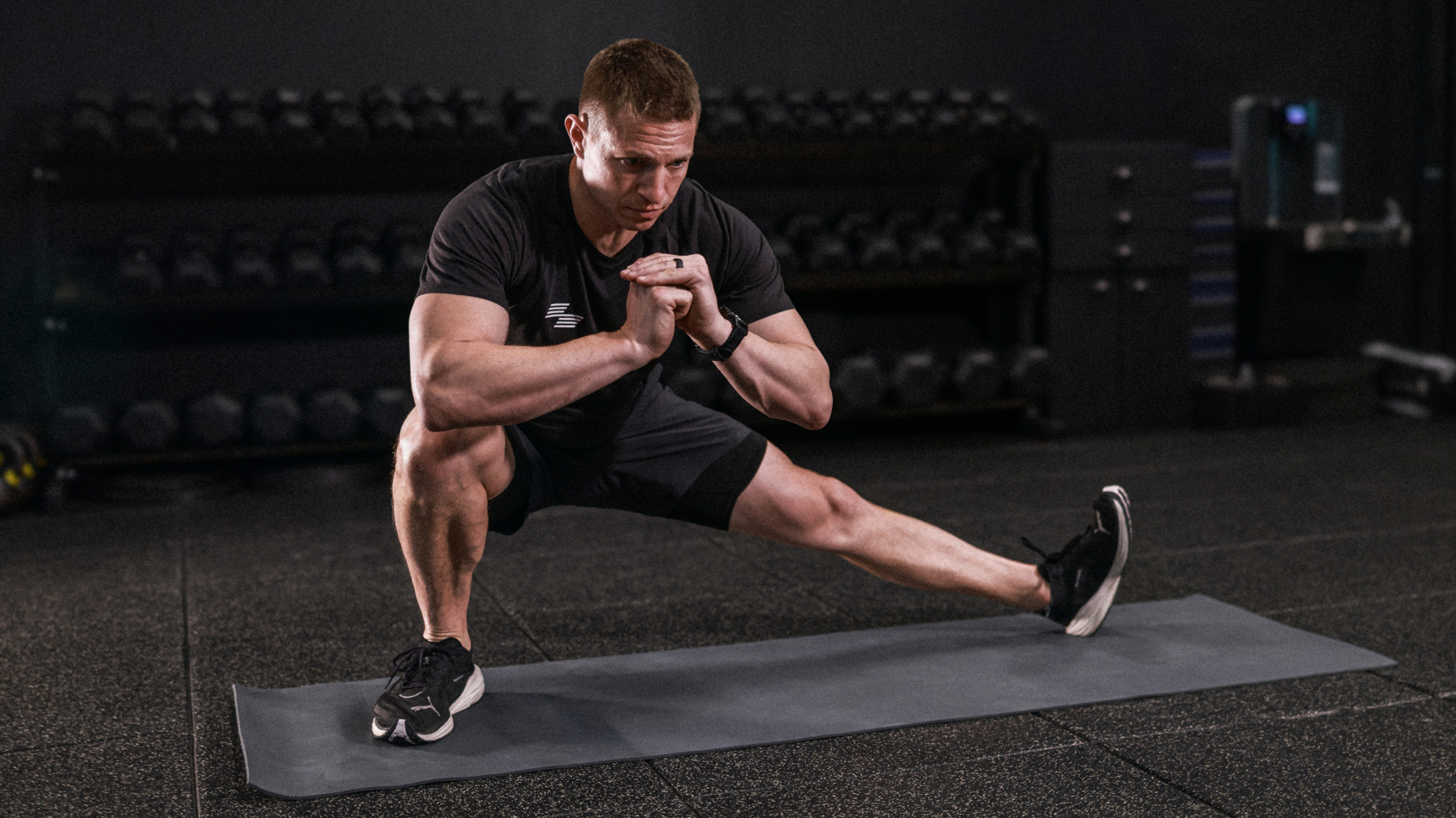 HYROX champion David Magida performs a side lunge.