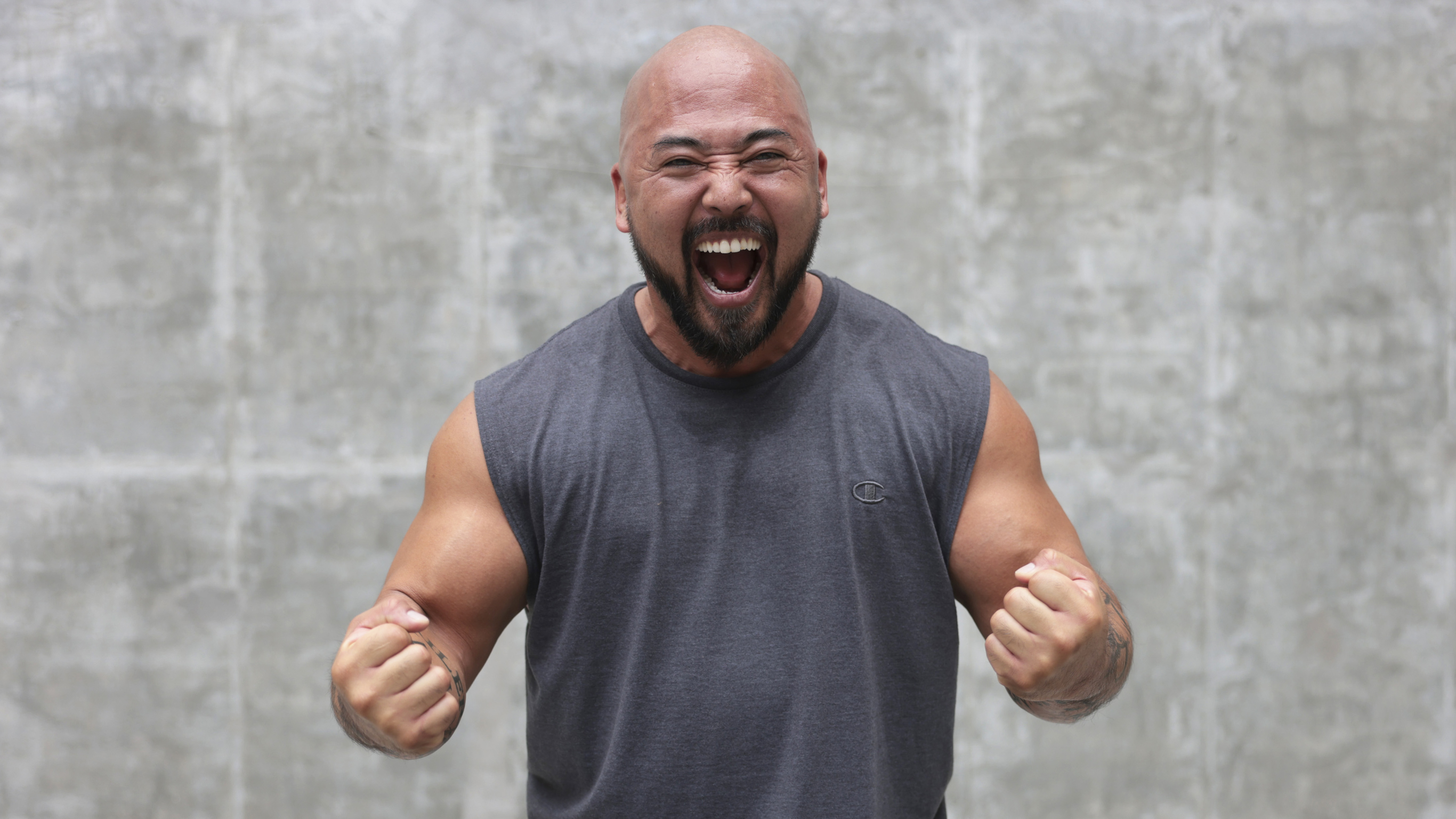 Da Rulk pulls a triumphant yes face, with arms bent 90 degrees at the elbow, hands in fists.