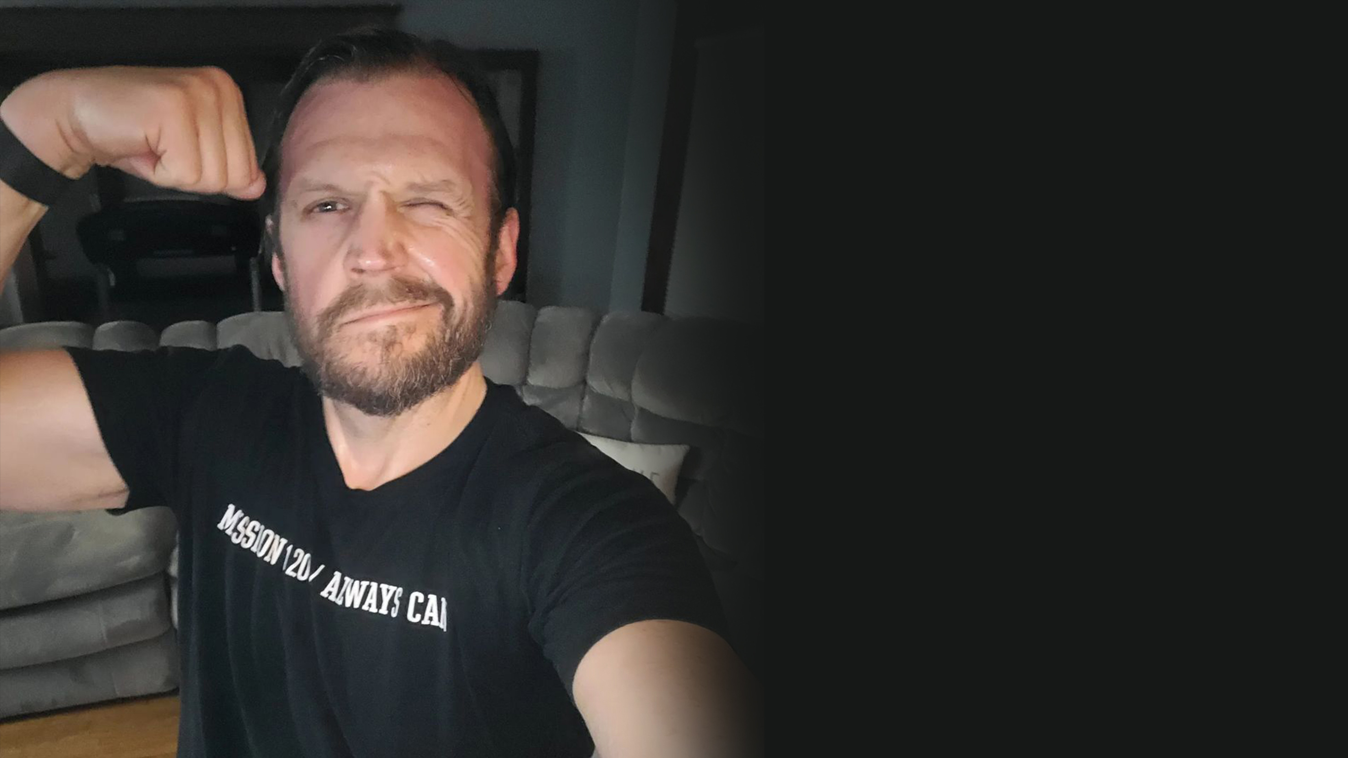 A selfie of Eric Hall flexing his bicep, overlaid with a motivational social media post made by Eric which shouts out Centr trainer Da Rulk.