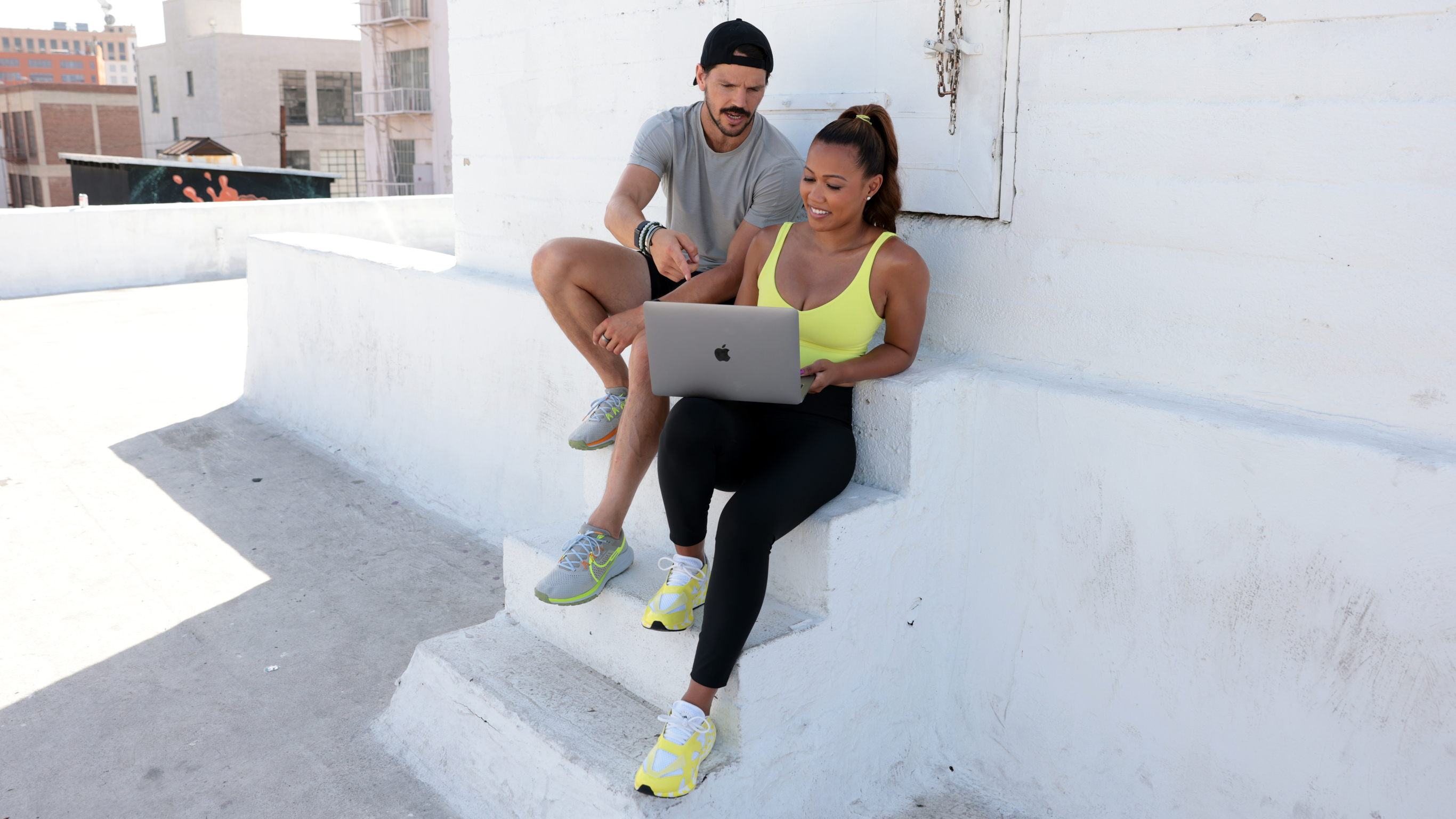 Dan Churchill and Maricris Lapaix share a laptop and browse the private Centr community.