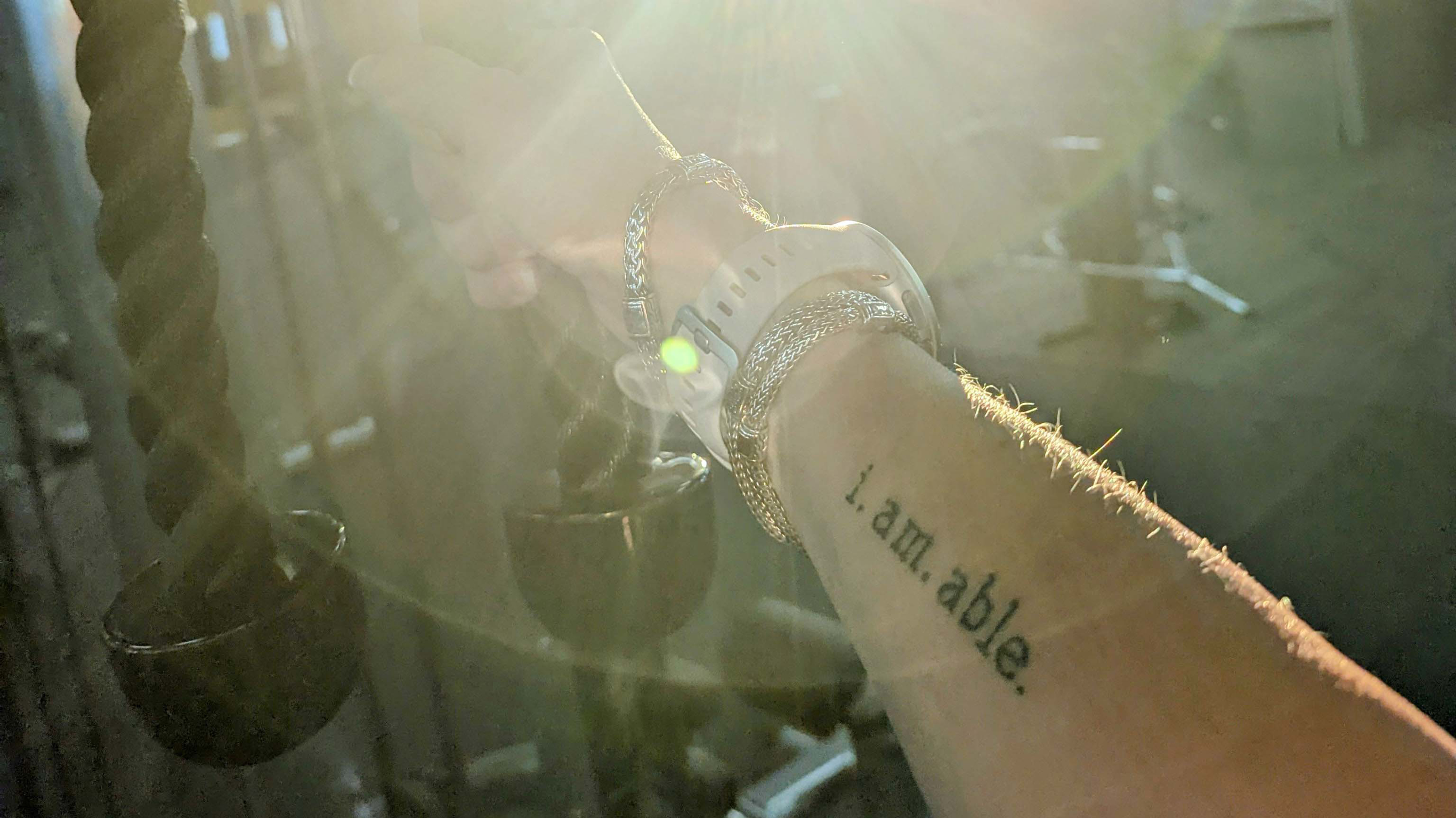 Centr member Christine's motivational tattoo, located on her inner forearm, which reads 'i. am. able'.