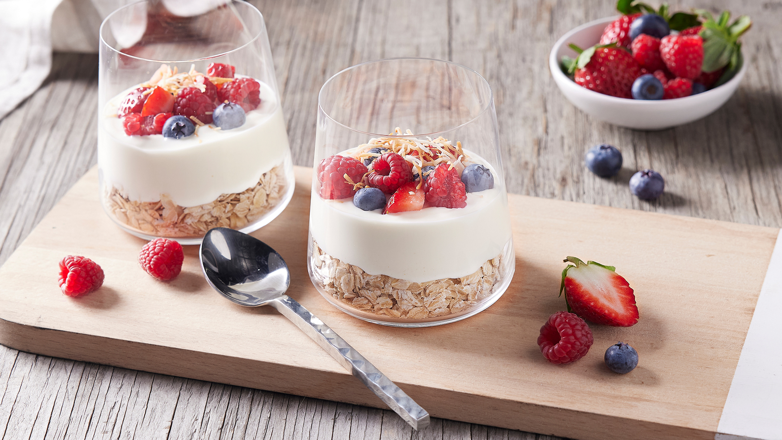 Two Overnight Yoghurt Parfaits sit on a chopping board. This breakfast, from the Centr recipe library, contains probiotic bacteria which can work to improve gut health.