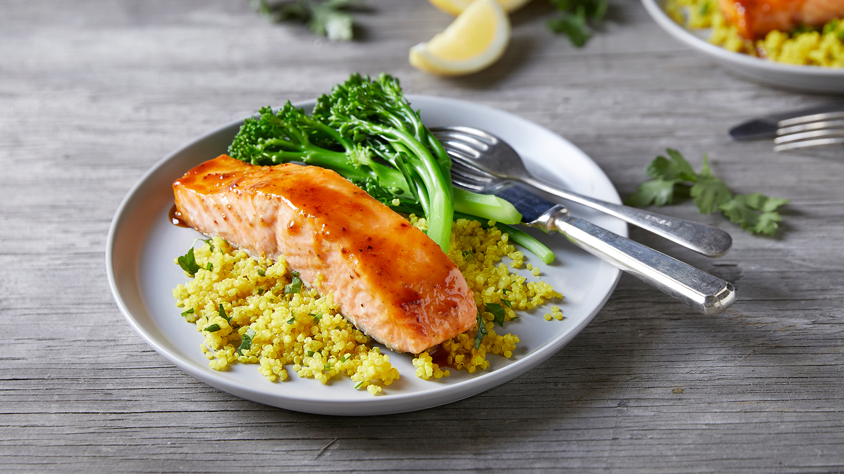 A plated Honey Miso Salmon & Turmeric Quinoa meal, from the Centr recipe library, sits on a table. This meal is rich in omega-3 fatty acids, which can be beneficial to brain function.