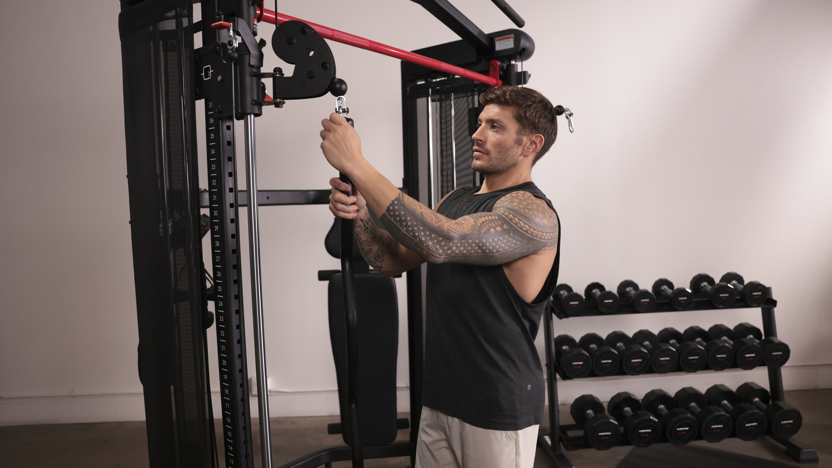 Chris Hemsworth's personal trainer Luke Zocchi uses a bar attachment for his Centr 3 functional trainer.