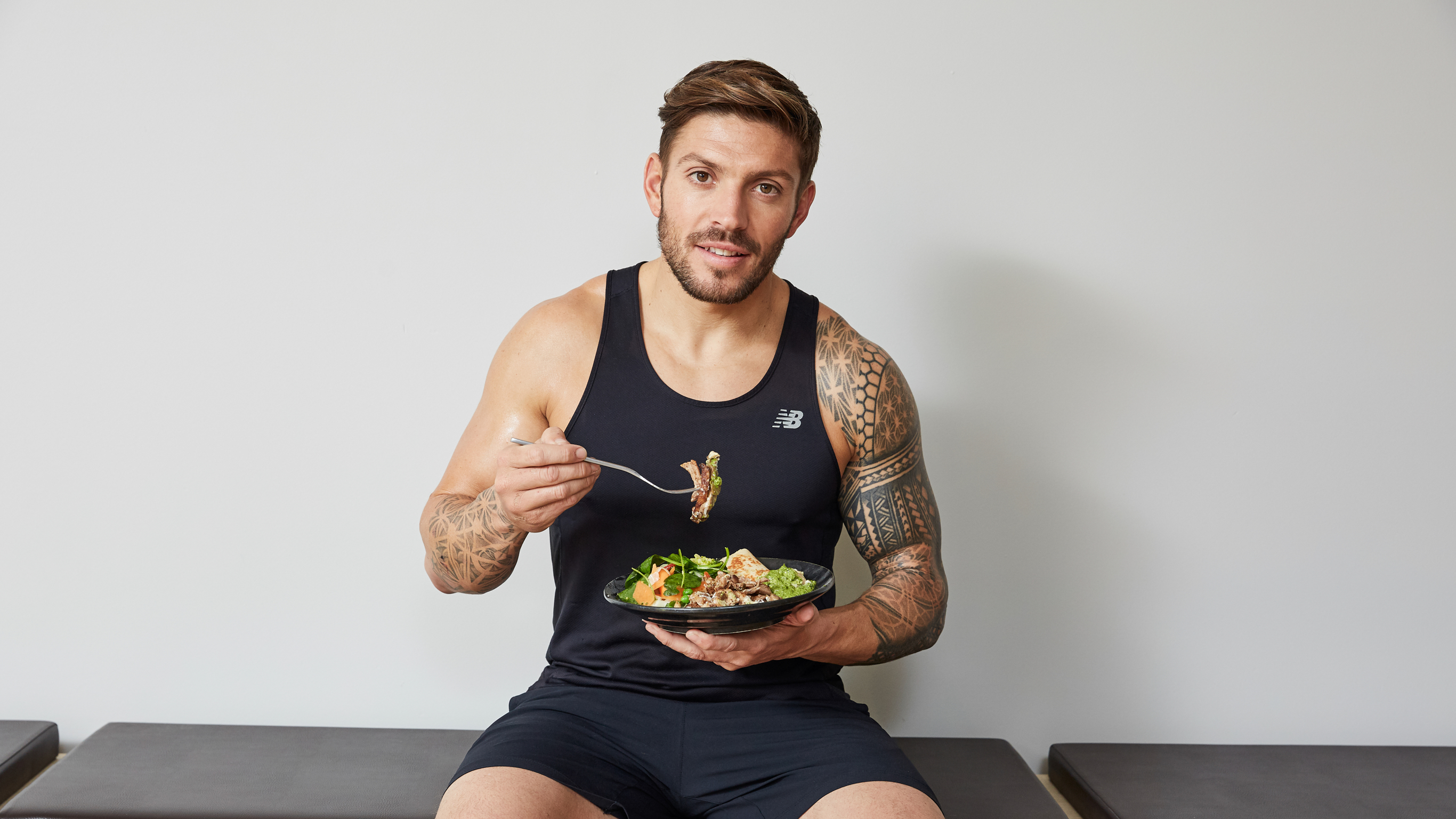 Centr trainer Luke Zocchi eats a salad from the Build Muscle Nutrition Guide.