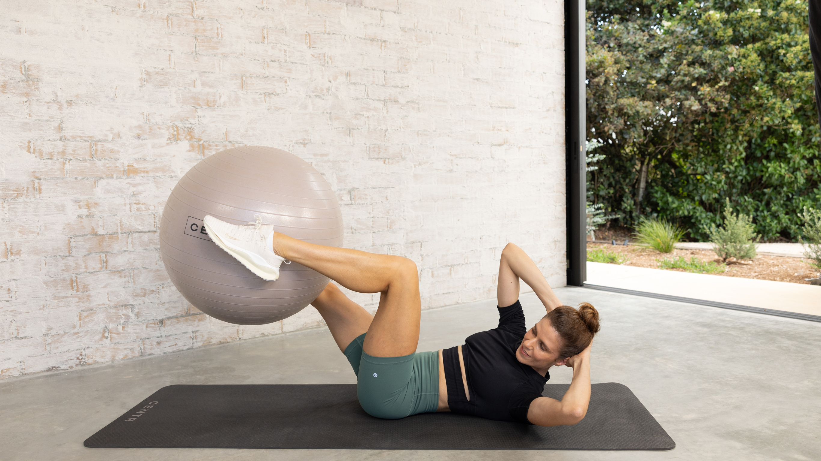 Centr trainer Silvia Roberts performs bicycle crunches.