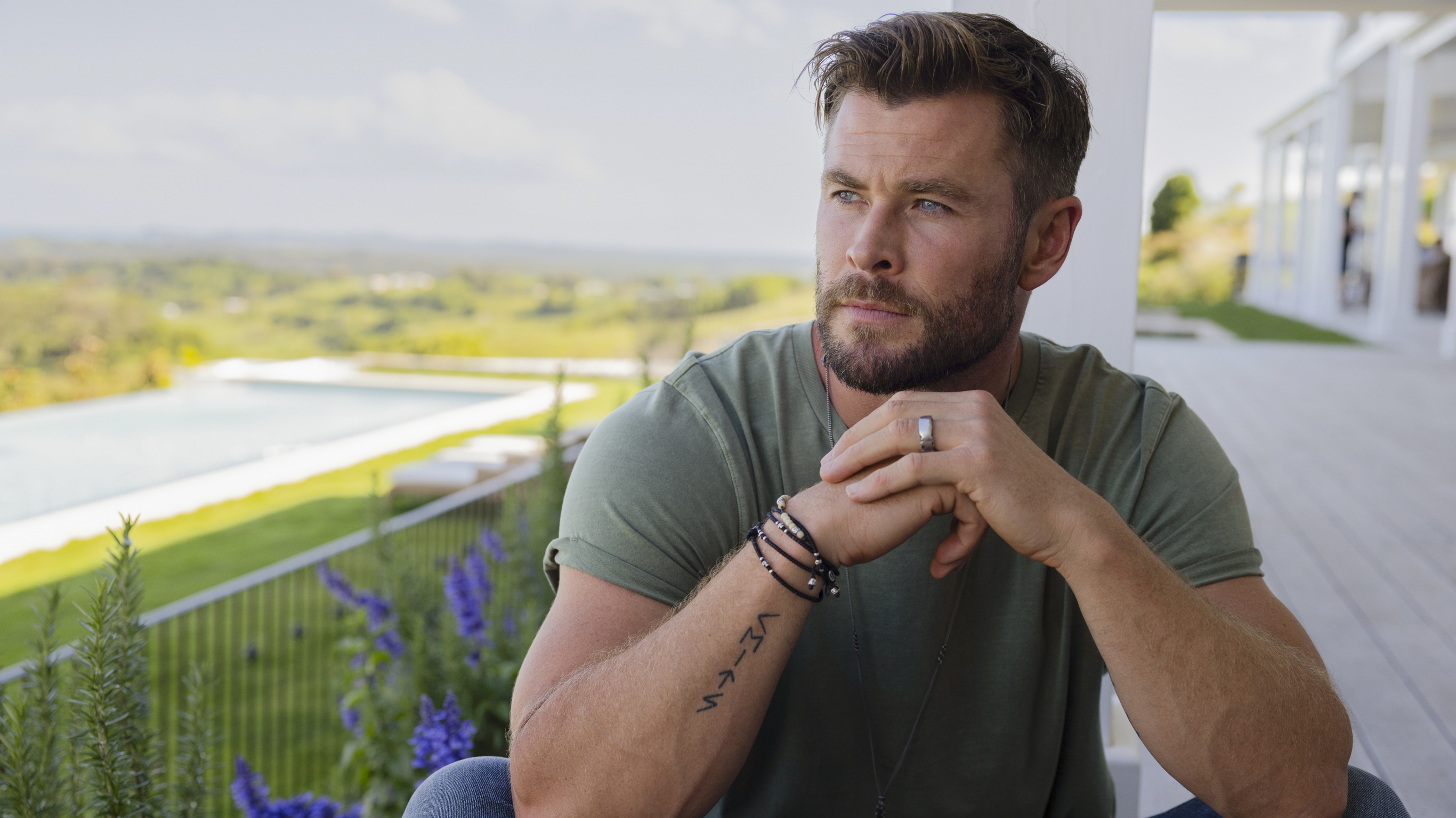 Chris Hemsworth sits on the front porch in sunny Byron Bay.