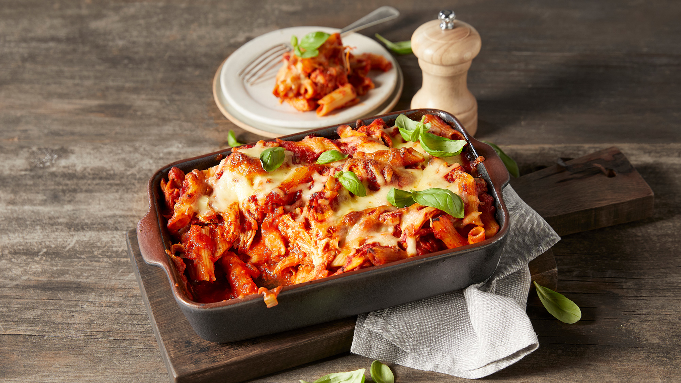 A tray of Smoky Tomato & Chicken Pasta Bake, from the Centr meal plan, sits on a table.