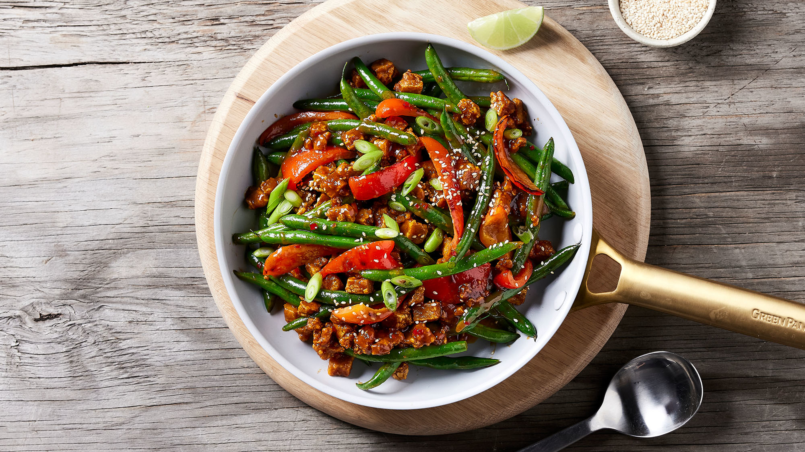 An overhead shot of a bowl of colourful almond butter tofu stir-fry.