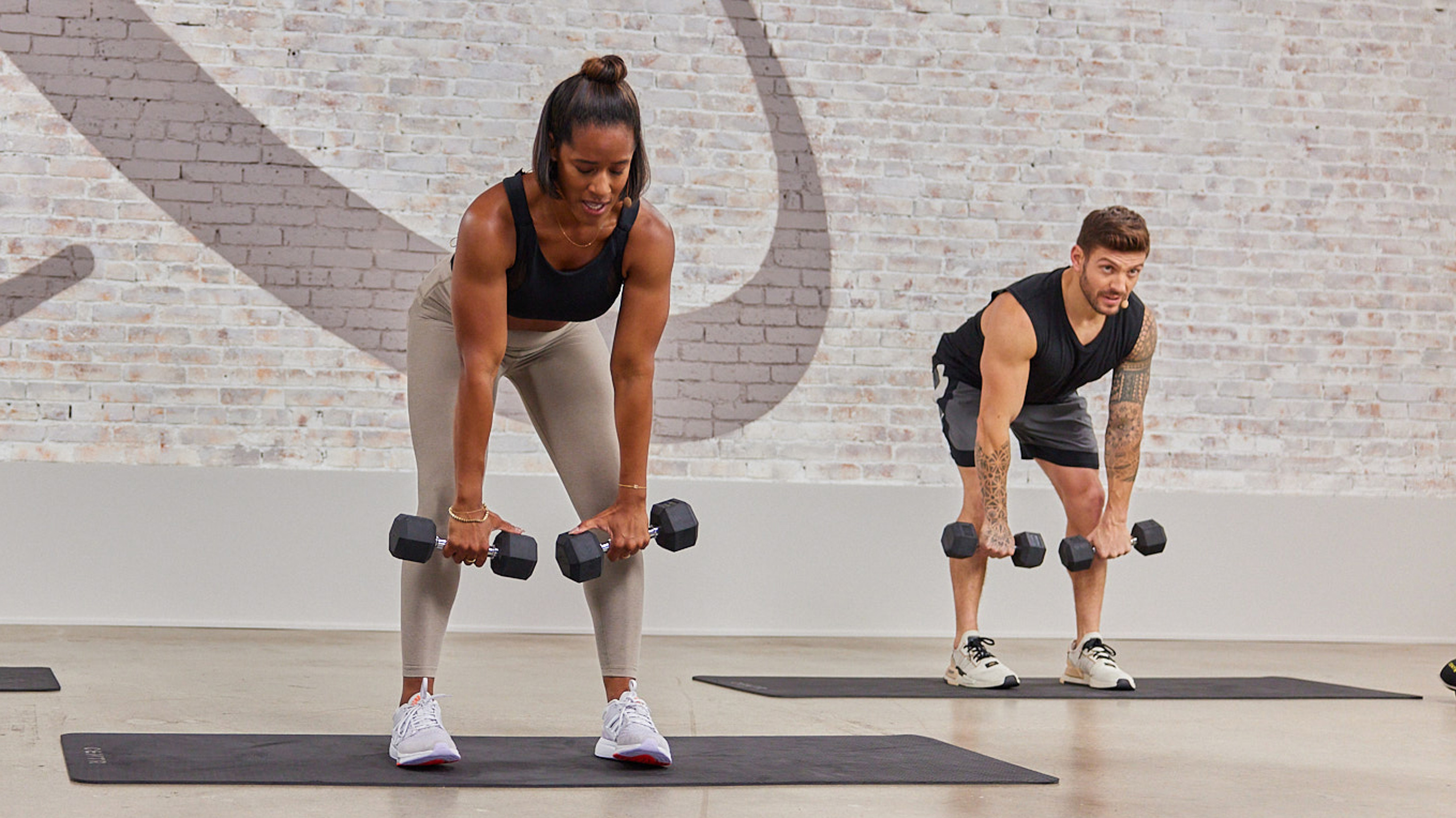 Centr Trainers Ingrid, Maricris & Luke perform a dumbbell deadlift, an exercise in the Functional Movement Challenge.