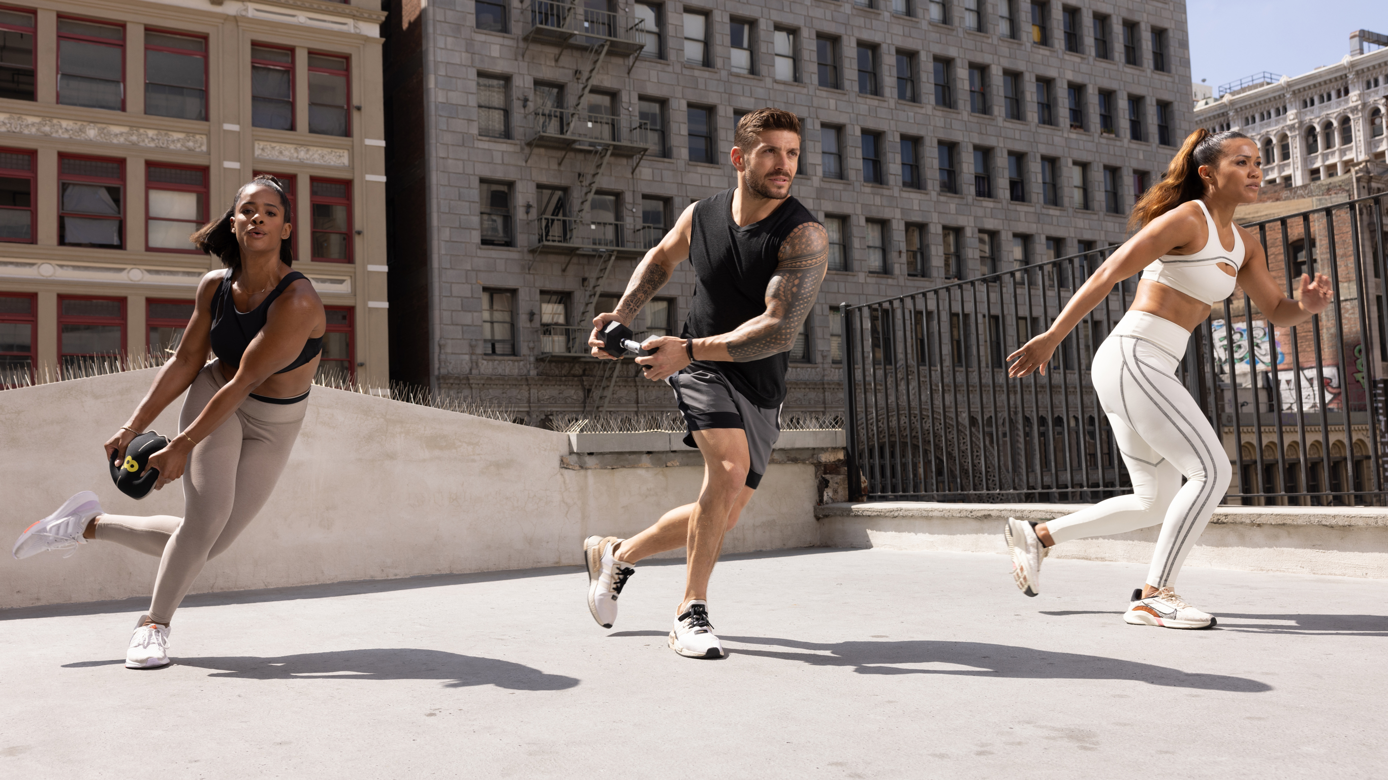 Centr trainers Maricris Lapaix, Ingrid Clay and Luke Zocchi perform skaters using Centr equipment during a Functional Movement Challenge workout.