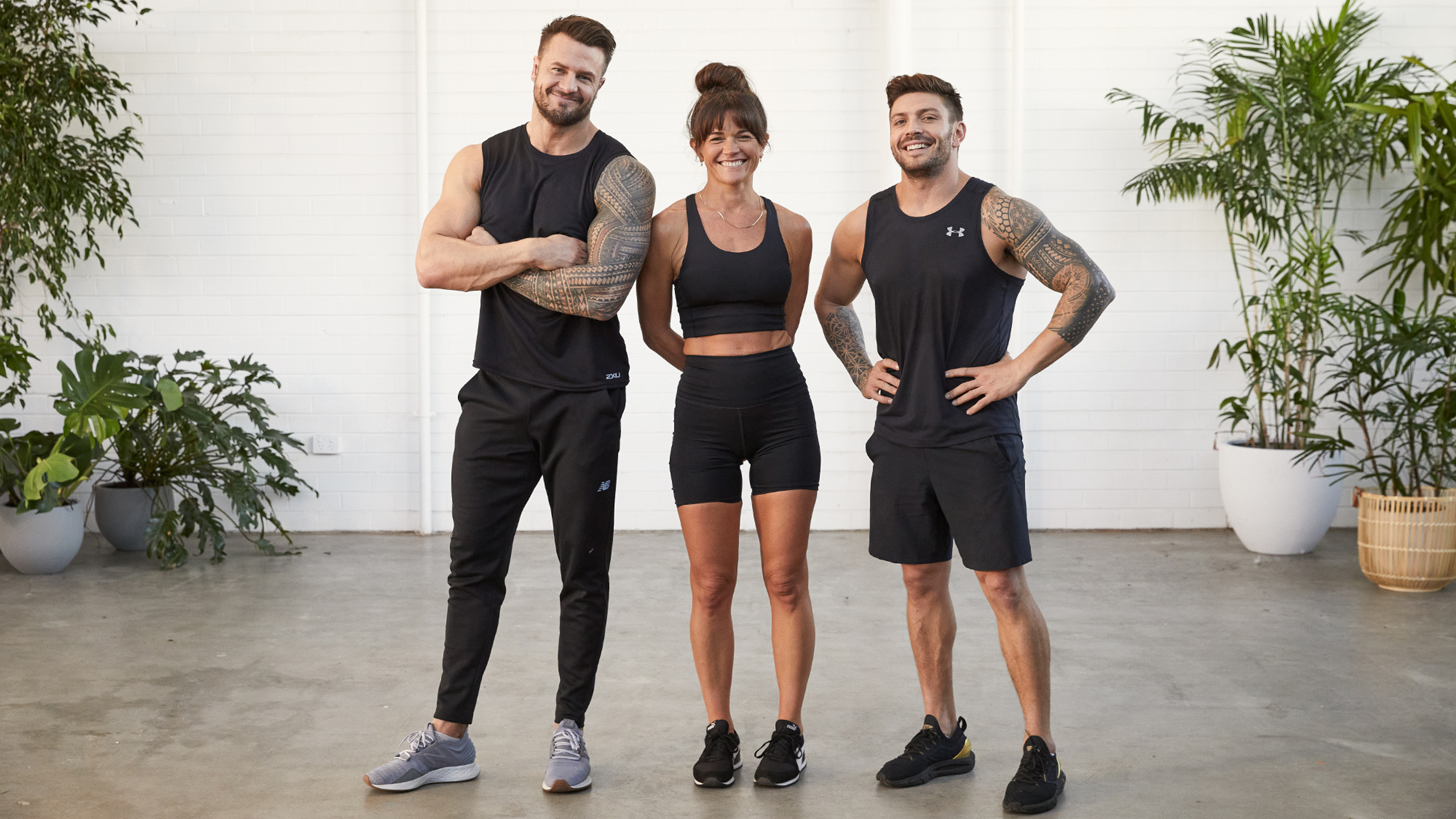 Cnettr trainers  Bobby Holland Hanton, Tahl Rinksy and Luke Zocchi smile and pose for the camera in a workout studio.