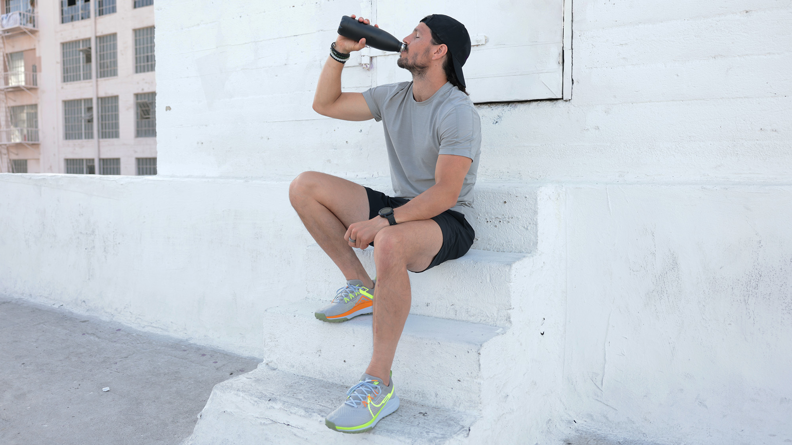 Centr trainer and chef Dan Churchill takes a big sip of water after a workout in the heat.