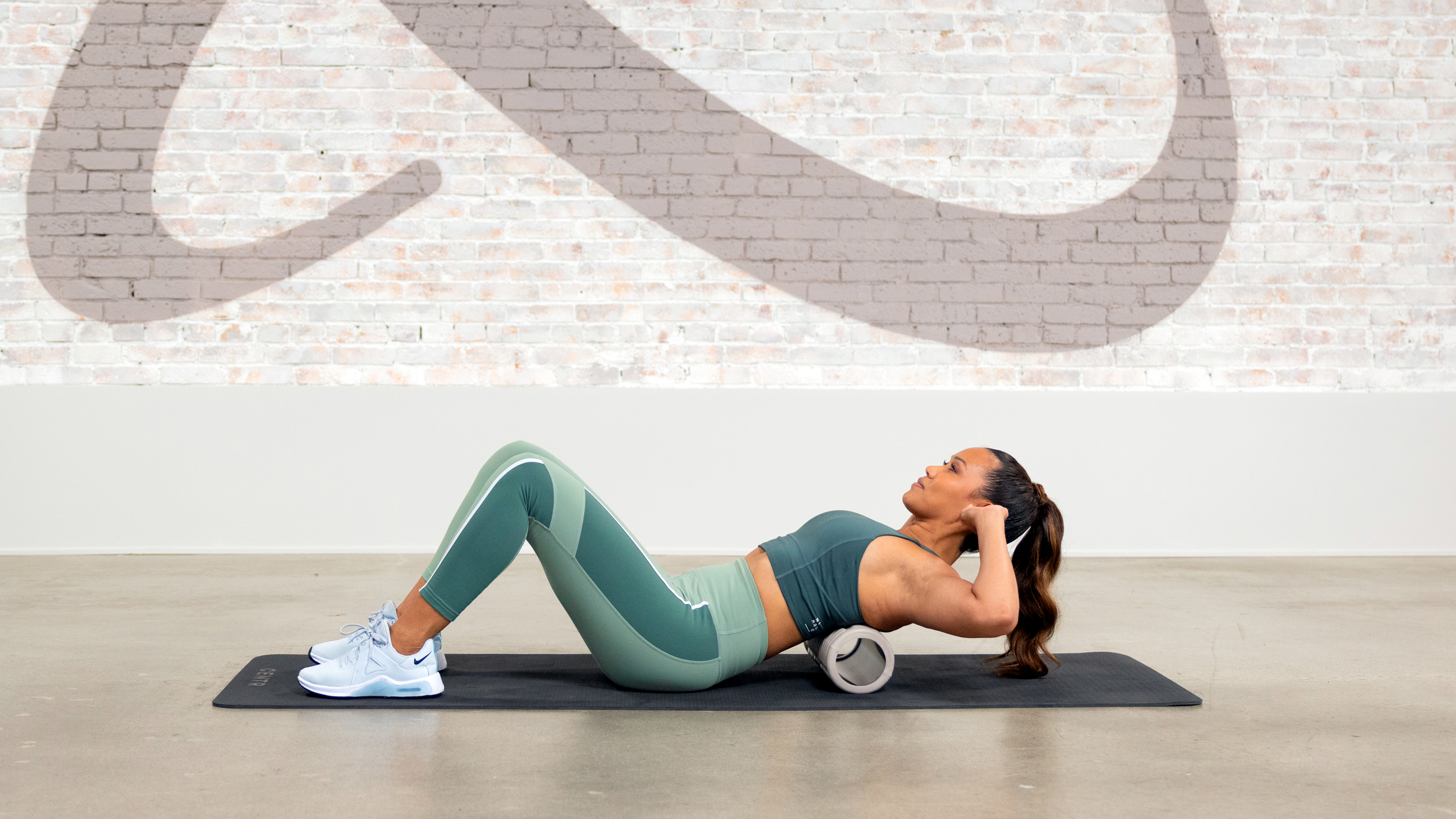 Cemtr trainer Mari-Cris Lapaix uses a foam roller to stretch out her spine.