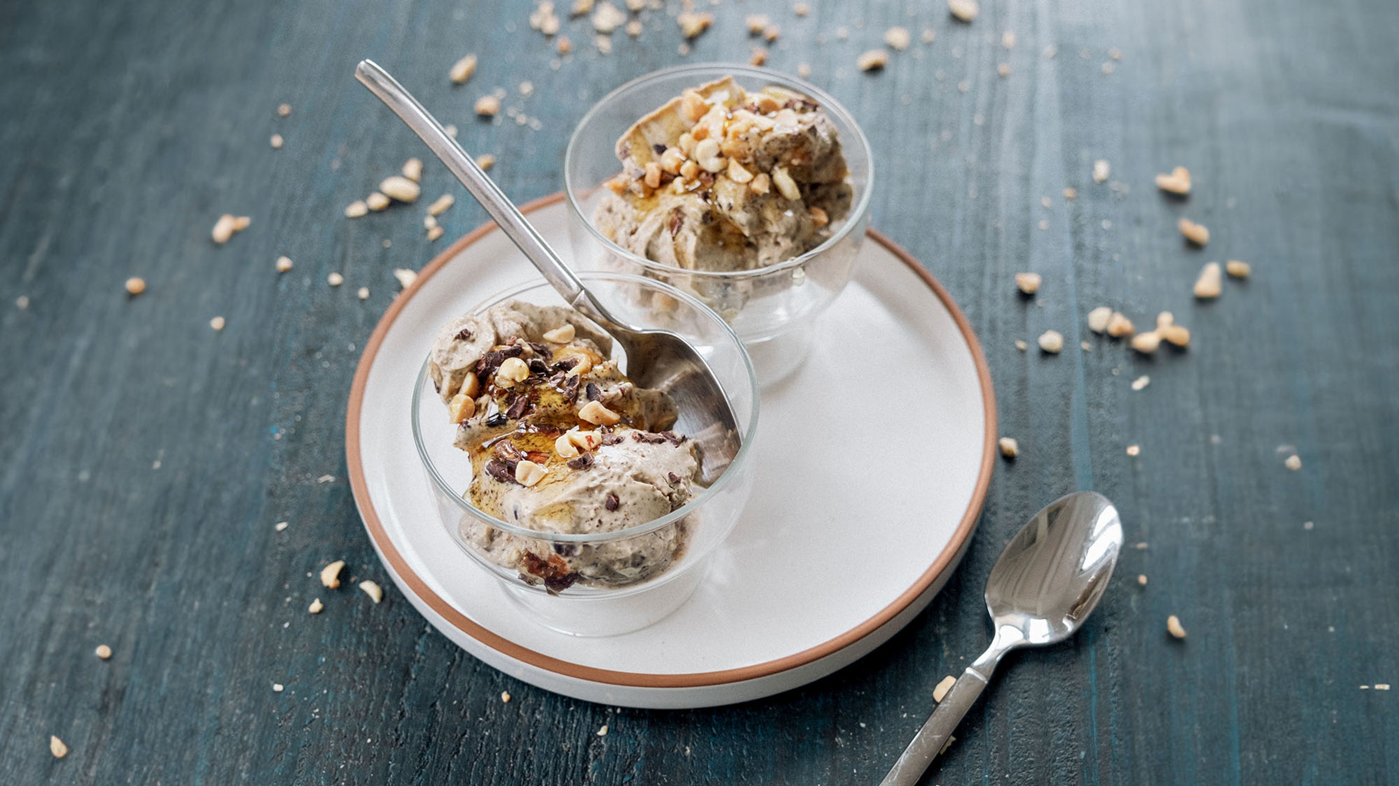 Two glasses of Dan's High-protein Cottage Cheese Ice Cream sit on a white plate, ready for eating.