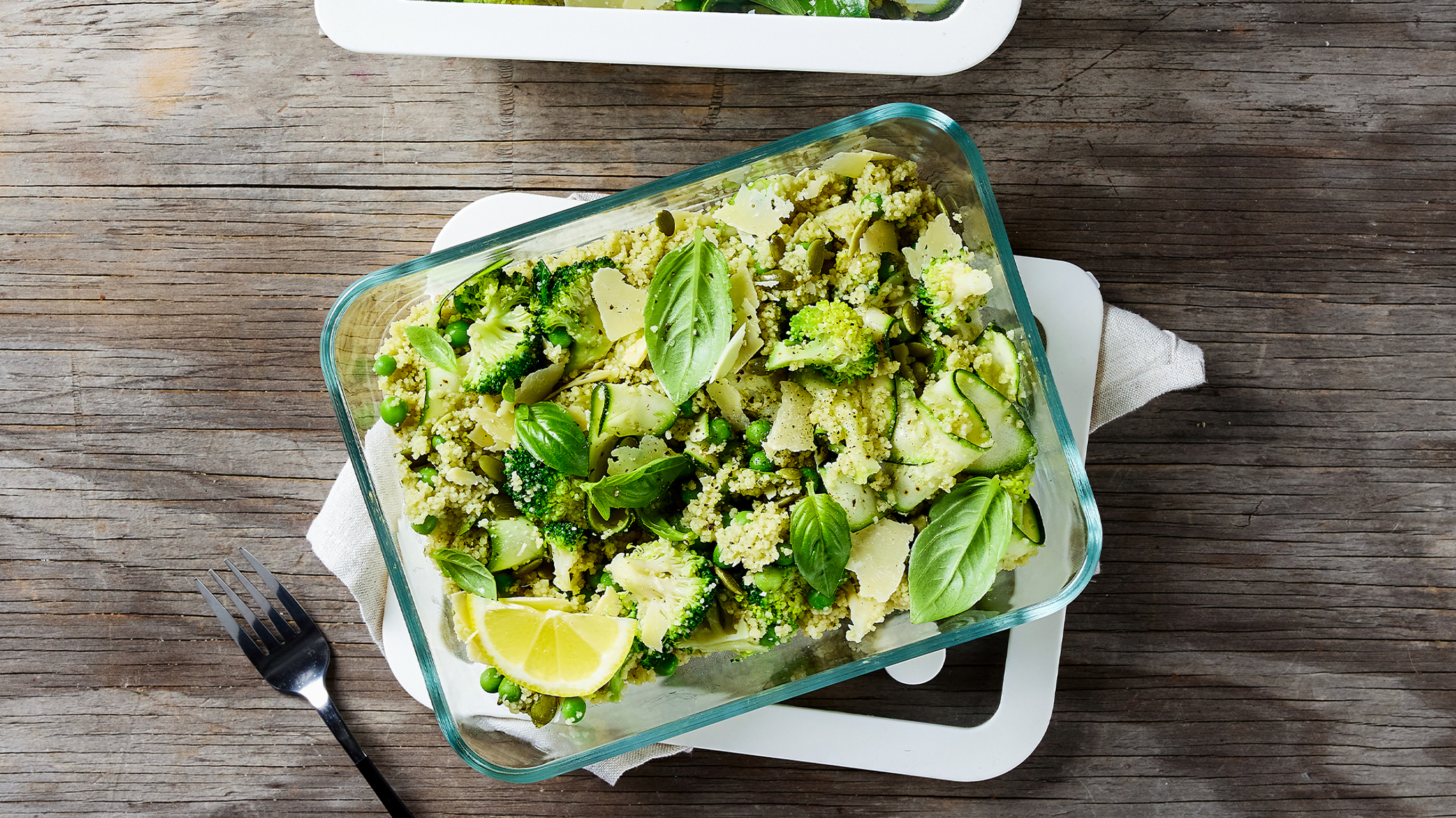 A dish of 10-minute Super Green Couscous Salad, from the Centr meal library, sits on a table.