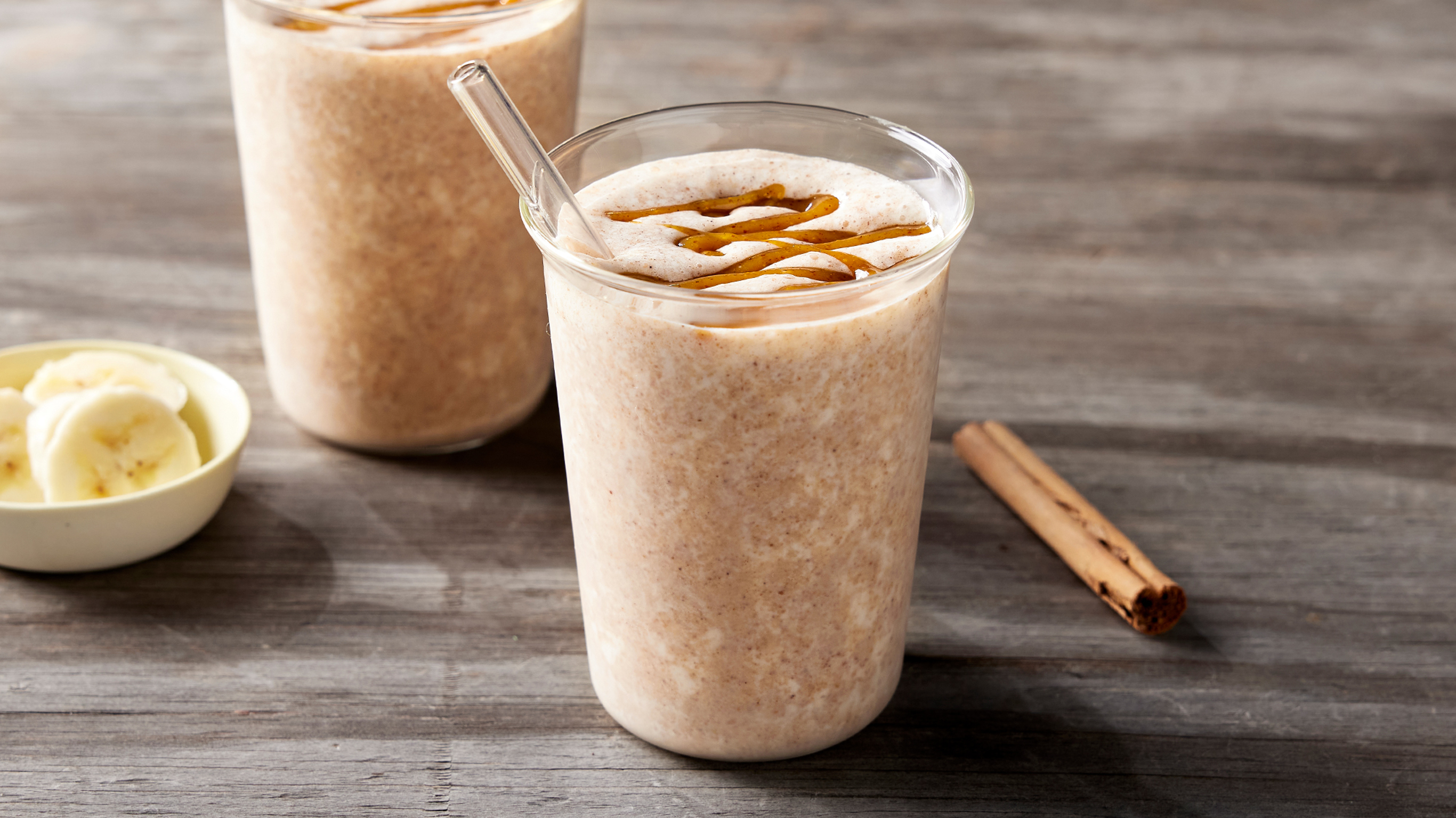 Two glasses of Biscoff-inspired Smoothie, from the Centr meal library, sit on a table.