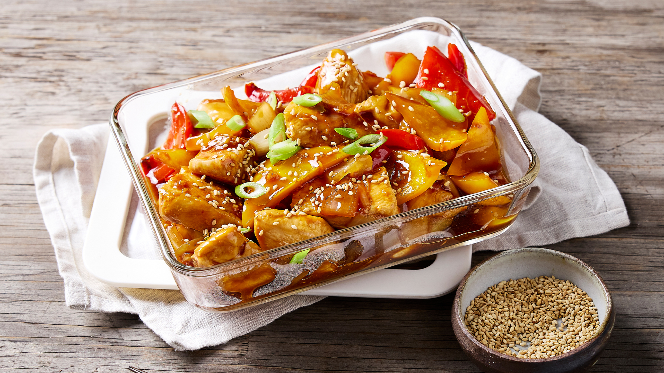 A dish of Sweet & Sour Chicken, from the Centr meal library, sits on a table.
