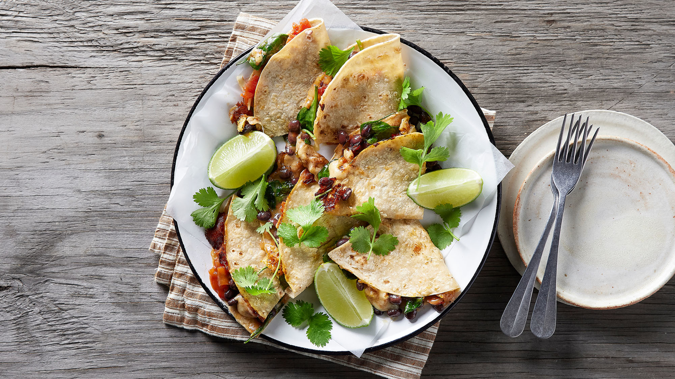 A plate of Centr's Cheesy Black Bean Quesadillas is ready to eat.