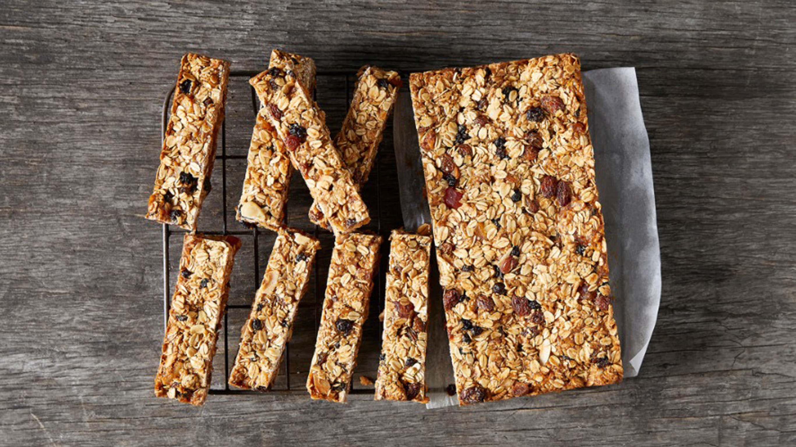 A fruit and nut bar has been chopped into smaller snack sizes ready to eat.