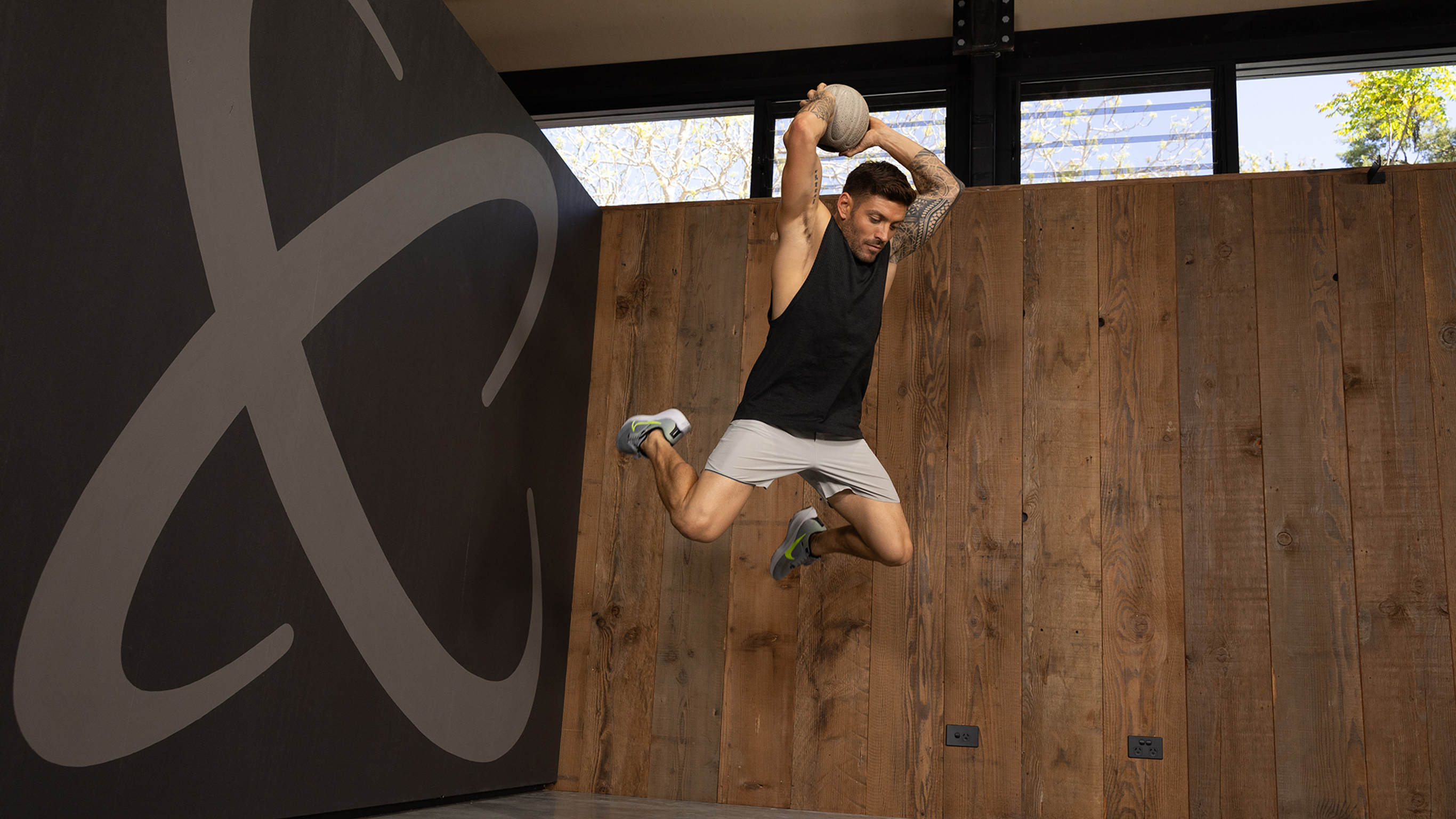 Centr trainer Luke Zocchi launches into the air, slam ball over his head as he prepares to slam the ball down.