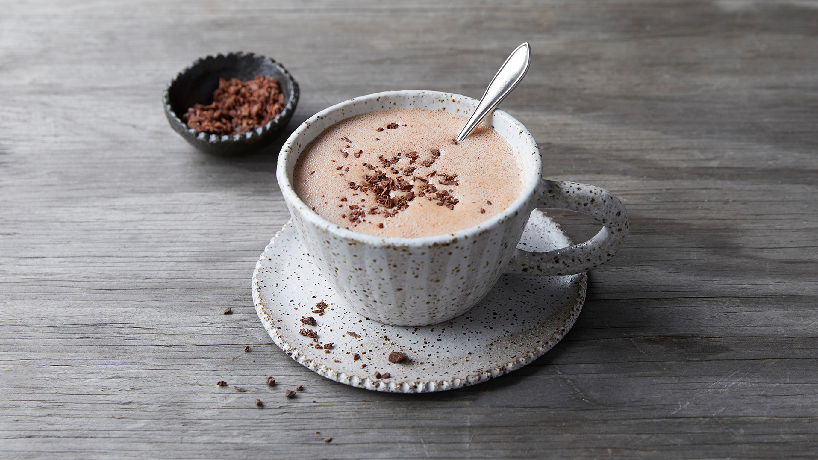 A stoneware cup of Centr's Cacao Peppermint Latte is ready for drinking.