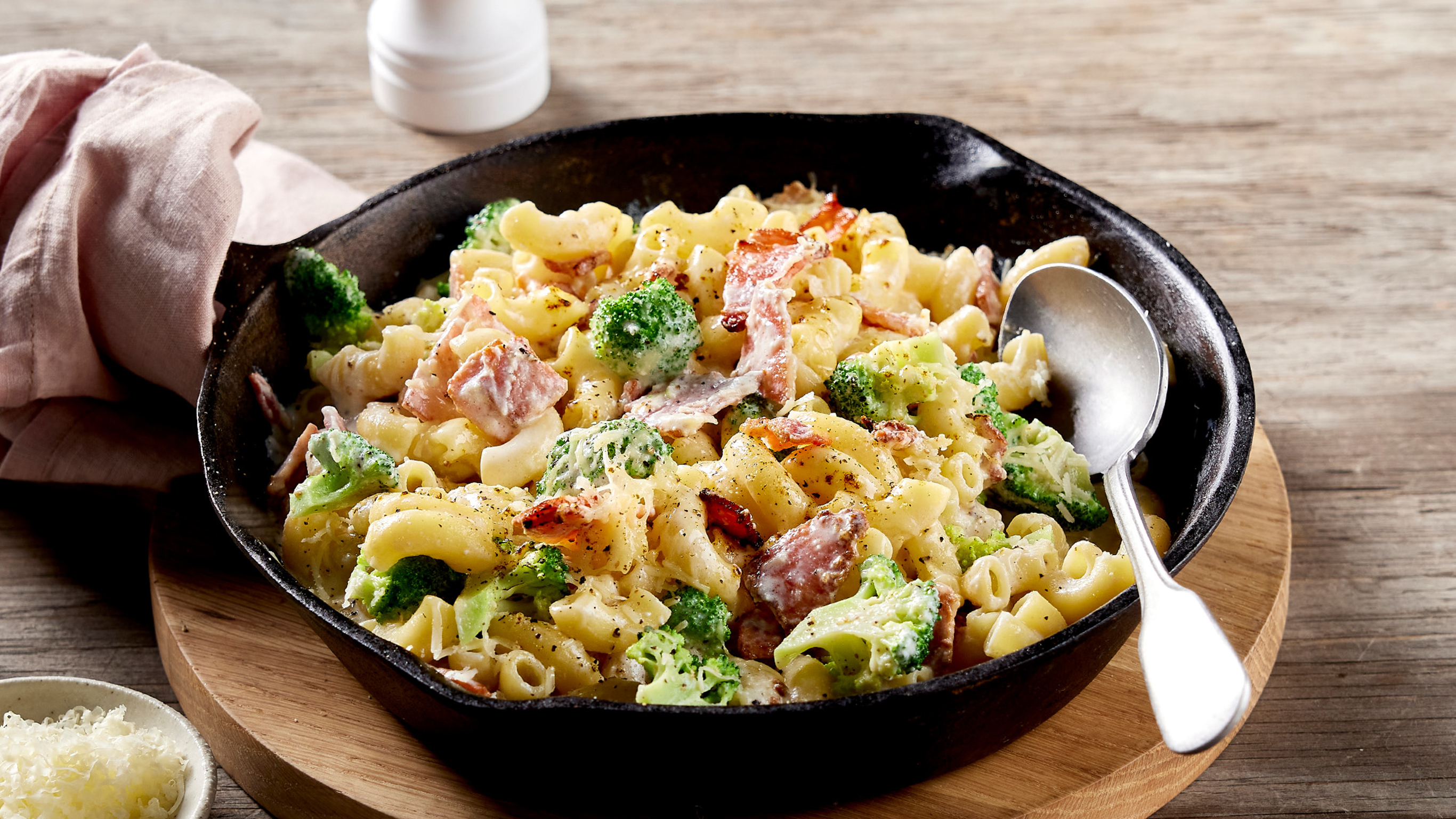 A skillet of 6-ingredient Broccoli Bacon Stovetop Mac & Cheese from the Centr menu is ready for serving.