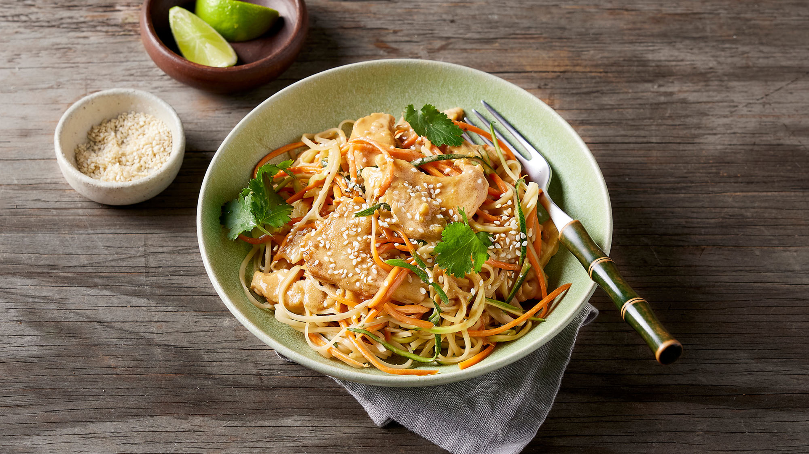 A bowl of Centr's Low-carb Chicken Satay with Veggie Noodles is ready for eating.