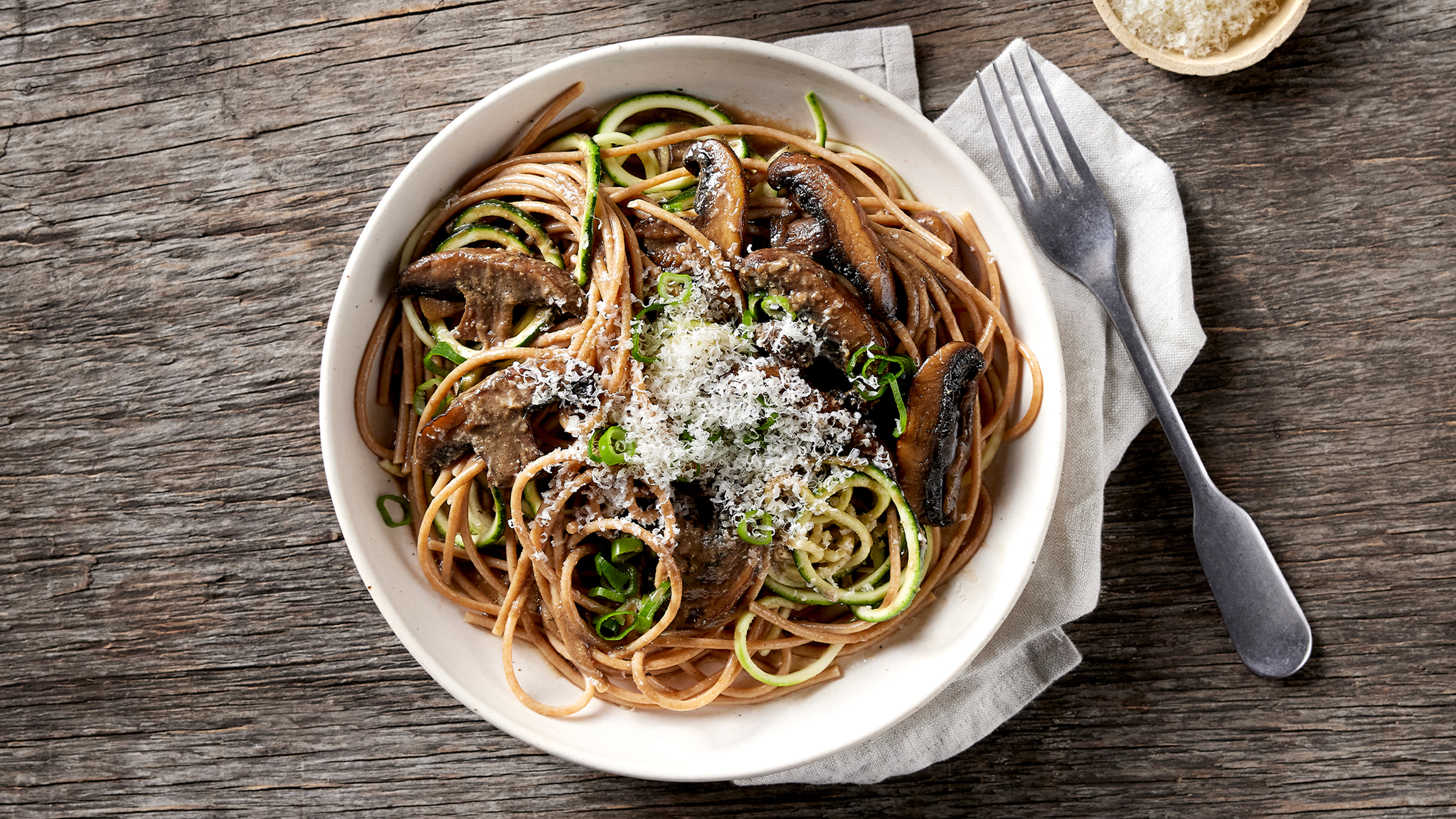 A bowl of Centr's Miso Mushroom Pasta is ready for eating.