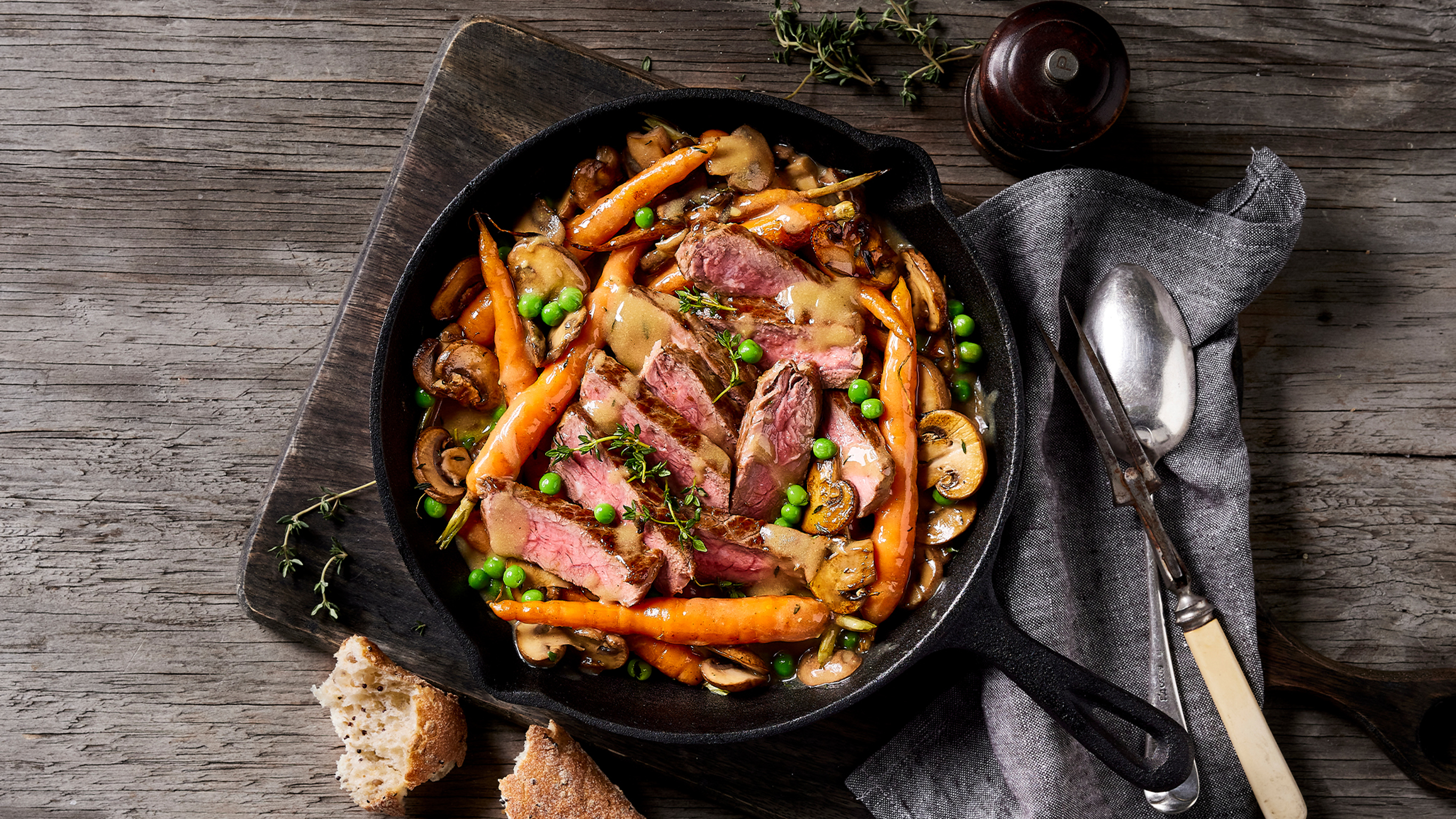 A cast-iron skillet of Centr's One-pan Steak with Mushroom Sauce is ready for serving.
