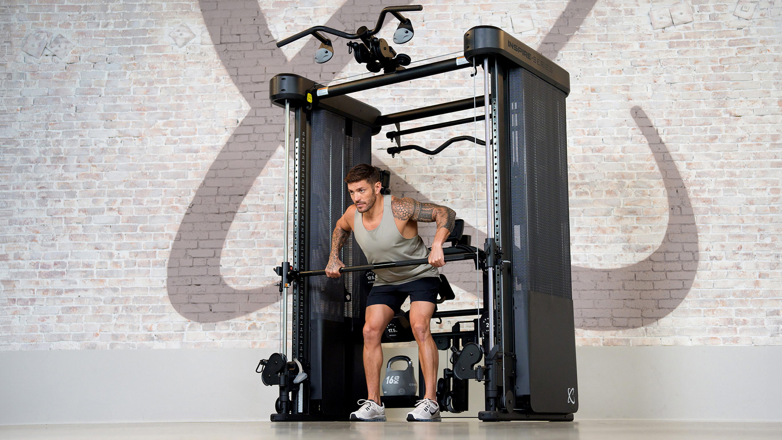 Centr tainer Luke Zocchi performs forward-bend rows on the FT2 PRO Smith Functional Trainer