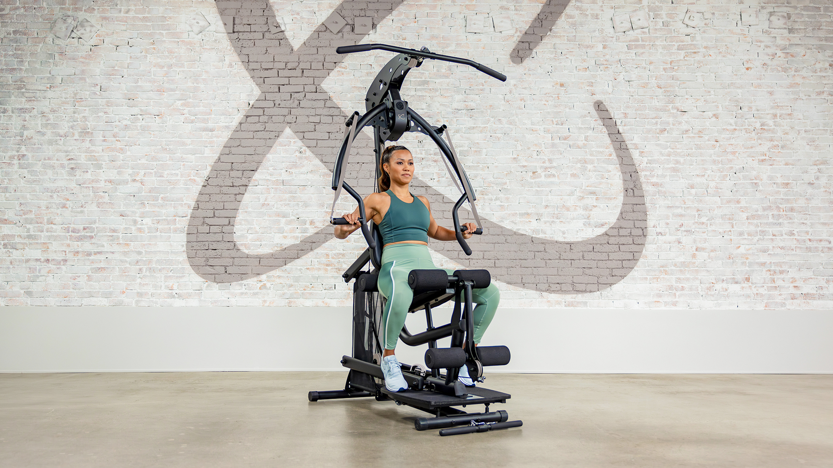 Centr trainer Maricris Lapaix performs chest press using the Centr Body Weight machine.