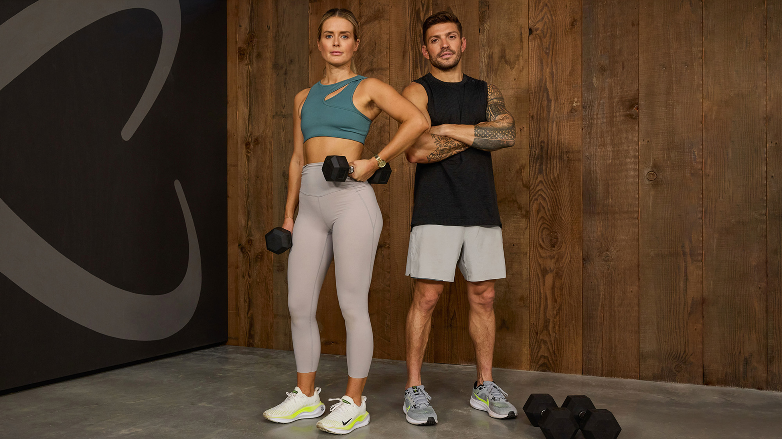 Alexz Parvi and Luke Zocchi pose with dumbbells for the camera.