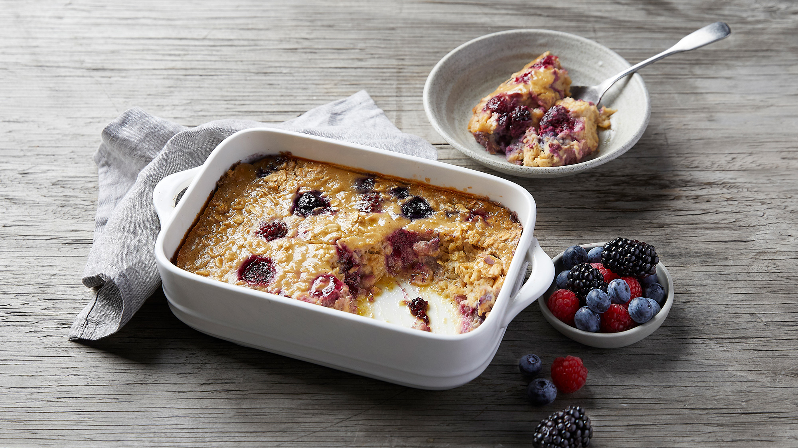A ceramic baking tray of Apple Berry Baked Oatmeal from the Centr menu is ready for serving