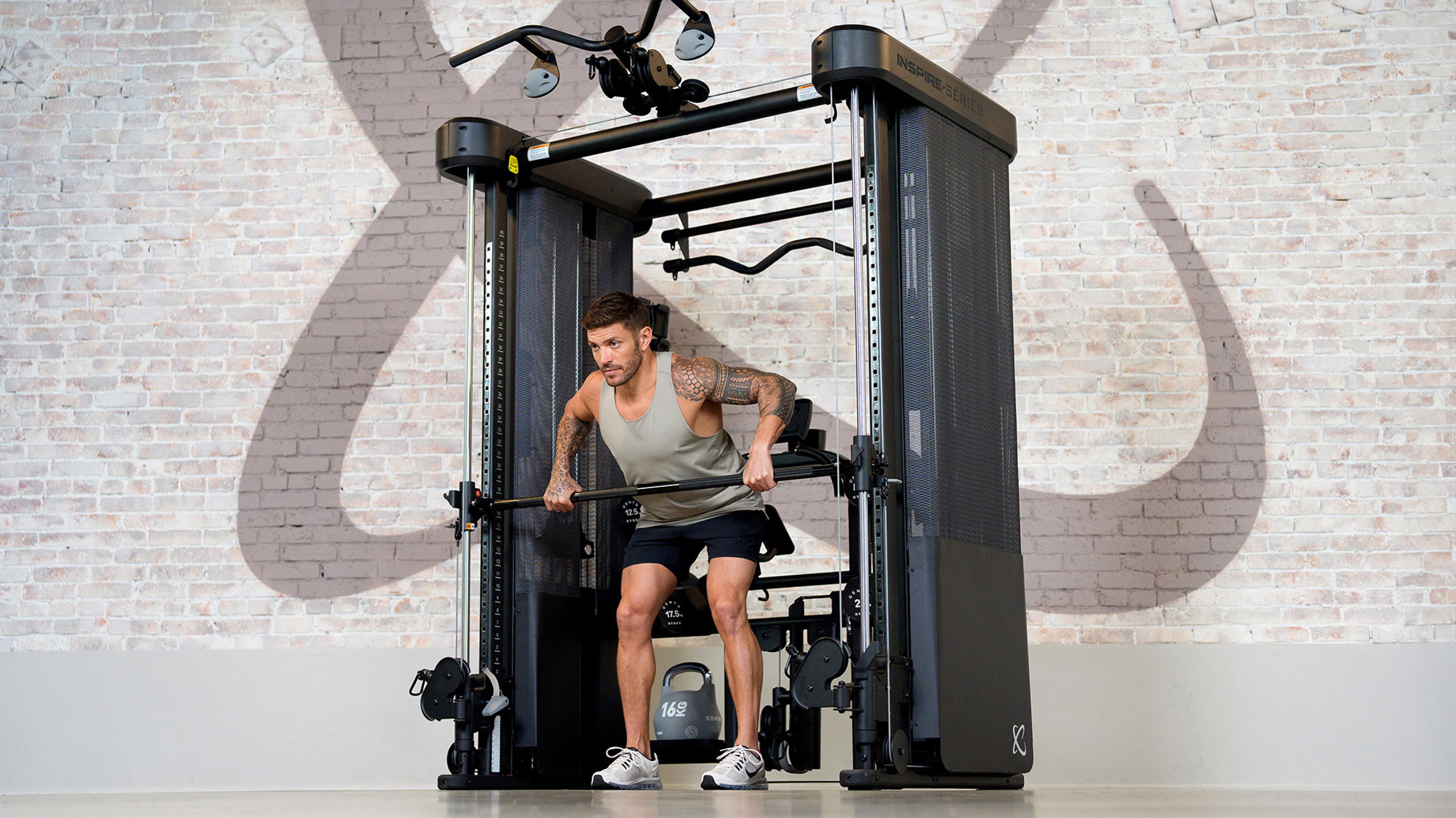 Centr trainer Luke Zocchi using an Inspire Series FT2 PRO cable machine.