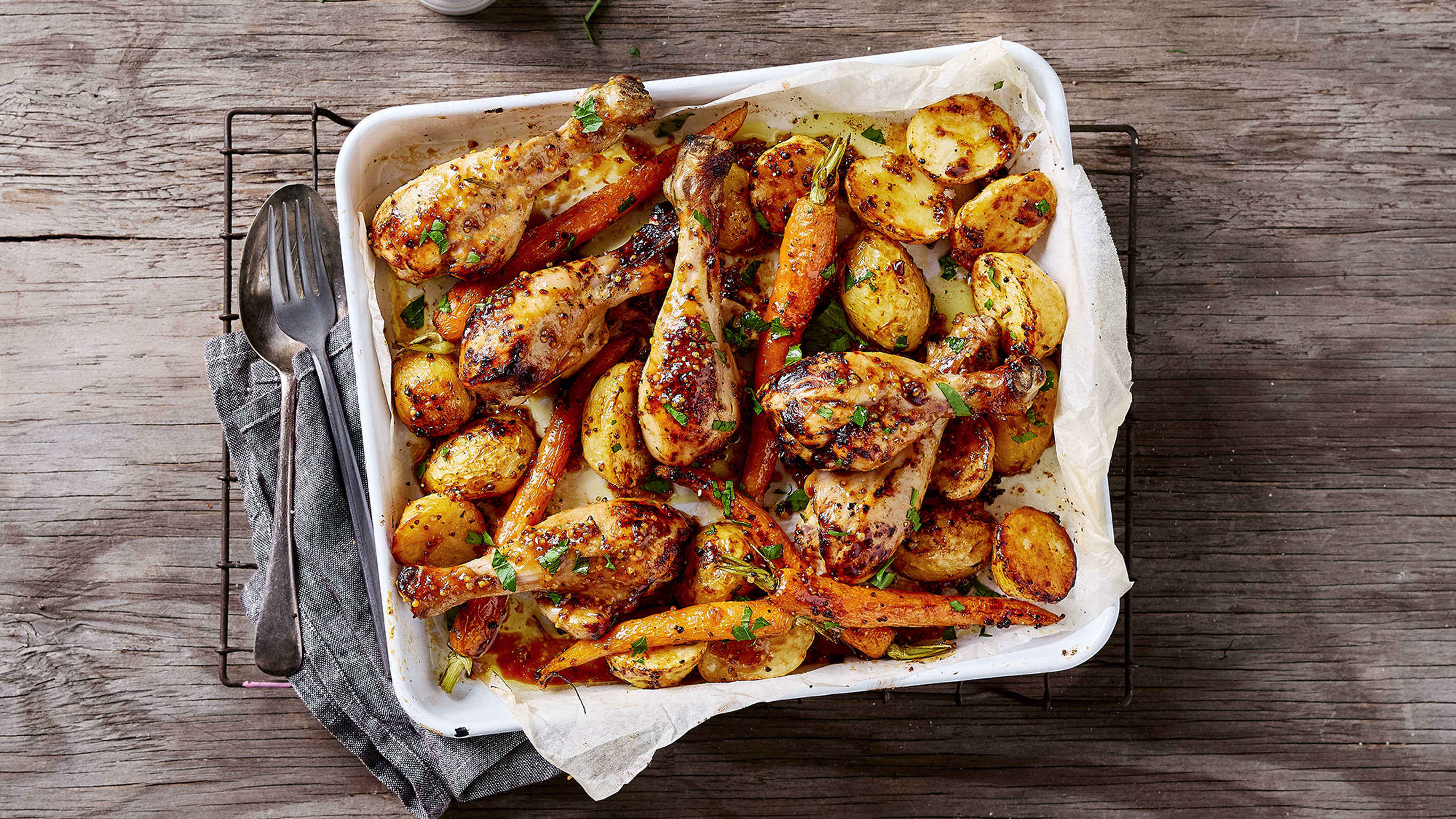 A ceramic tray of Centr's Honey Mustard Chicken & Potato Sheet-pan is ready for serving.