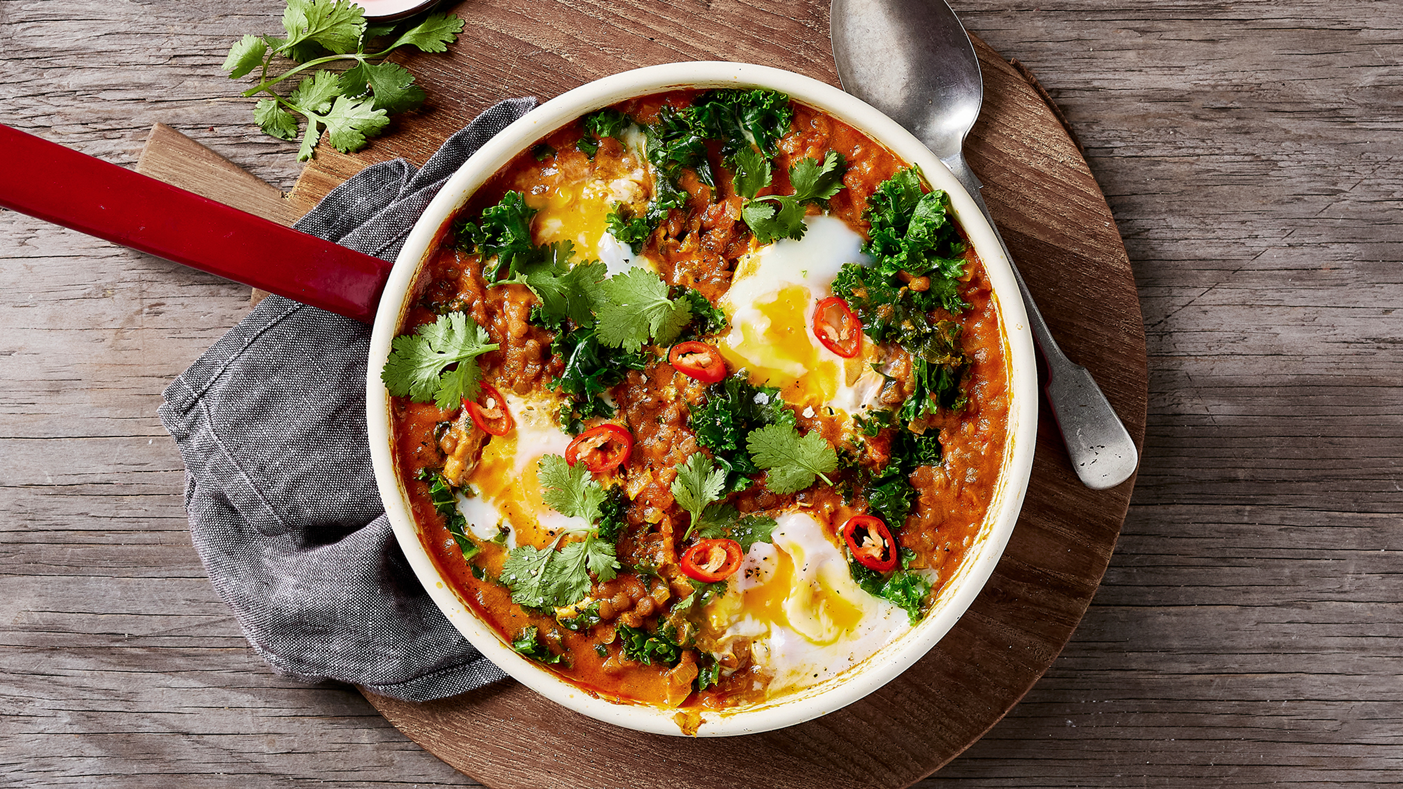 A round skillet of Centr's Indian-inspired Lentil Shakshuka is ready for serving.