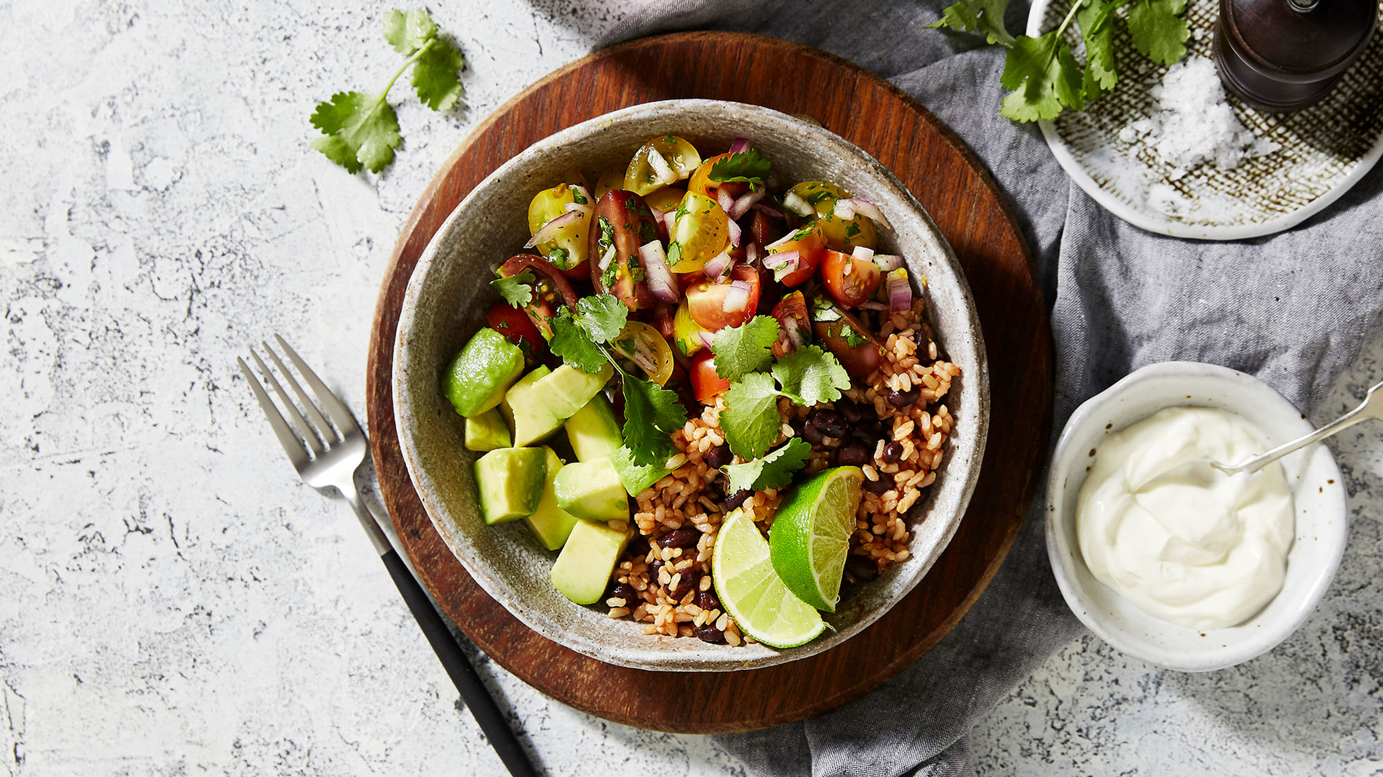 A bowl of Centr's Spicy Mexican Brown Rice Bowl is ready for eating.