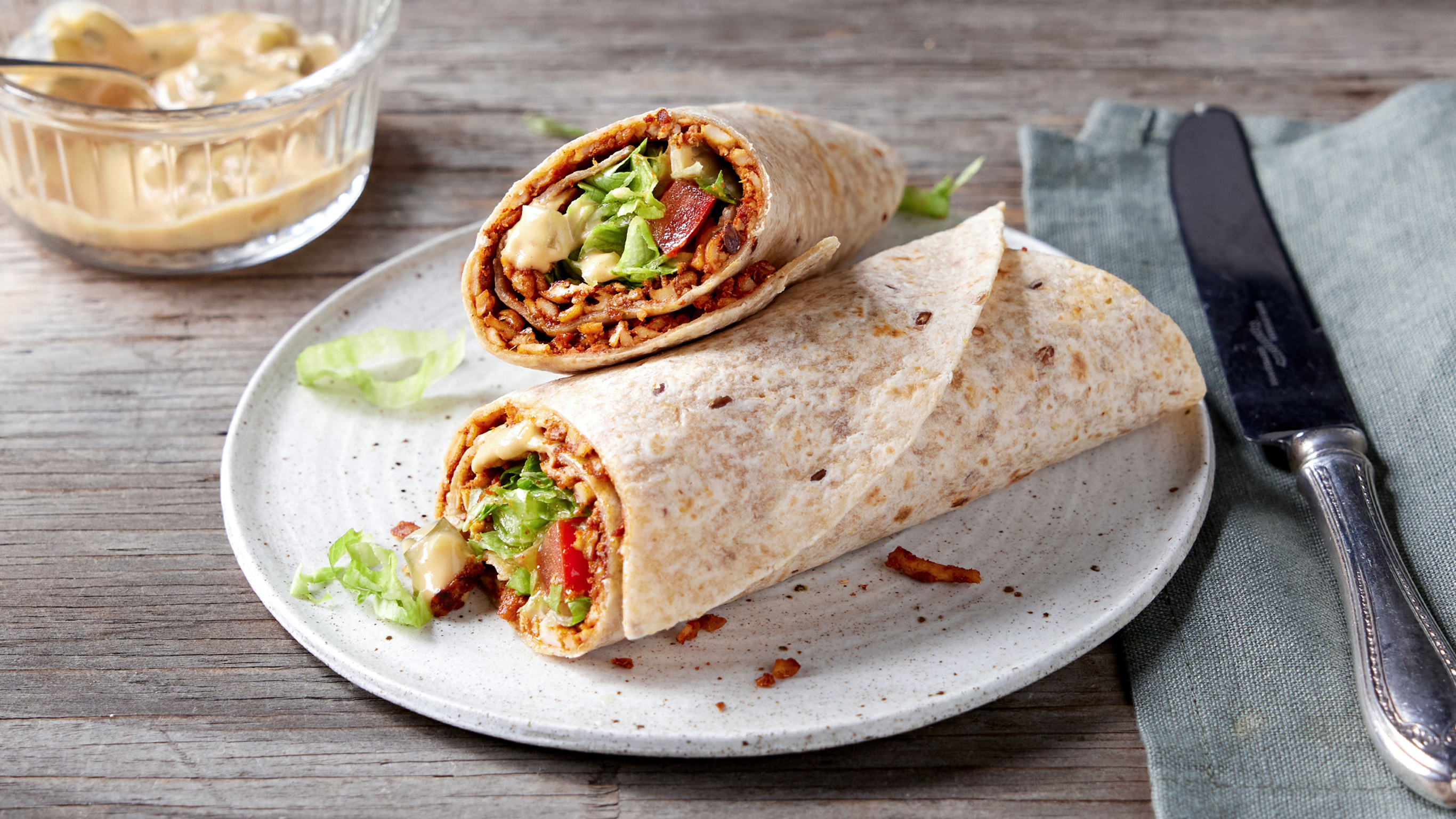 A plate with two Tofu Smash Wraps with Secret Sauce from the Centr menu are ready for eating.
