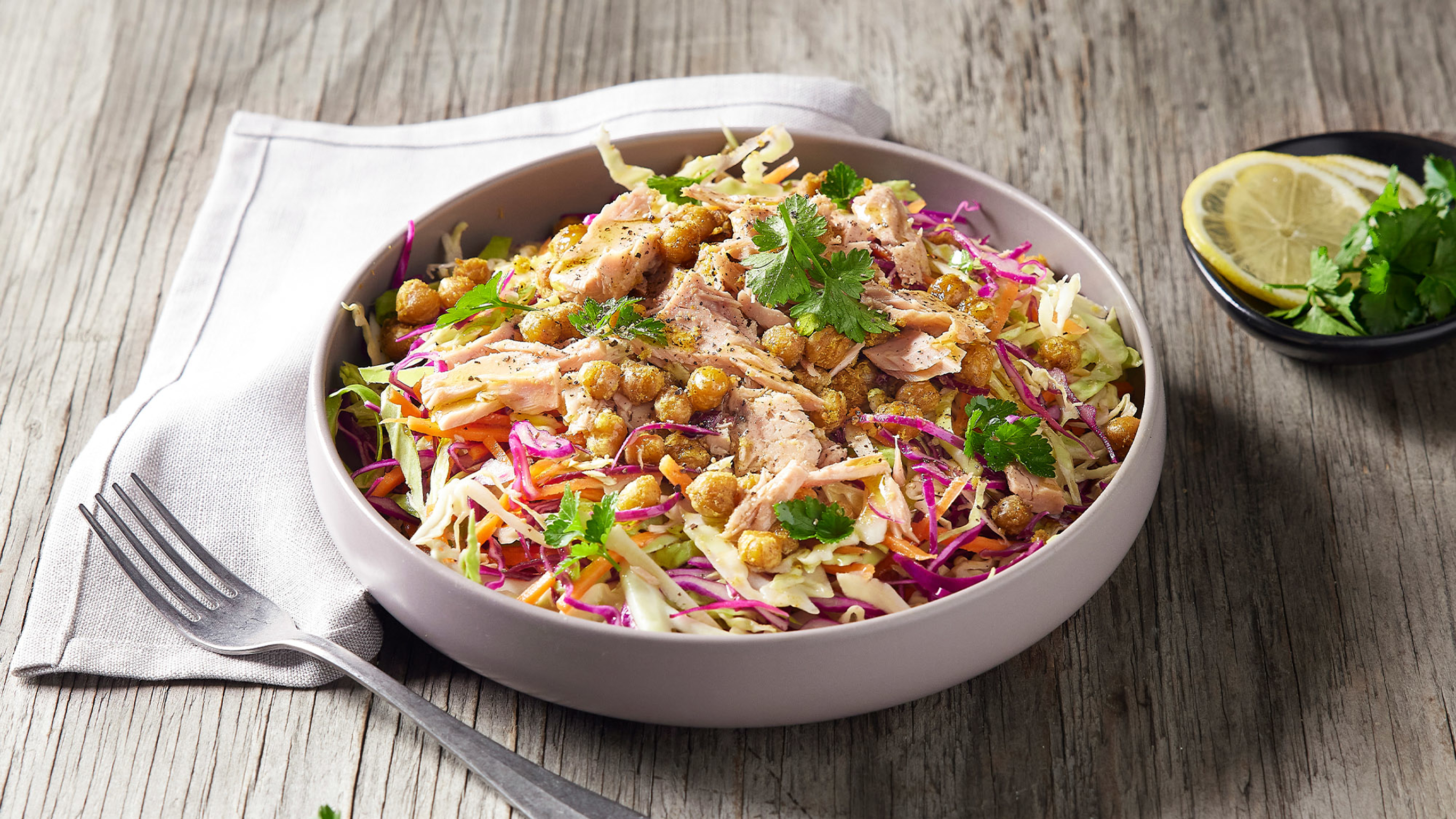 A round dish of Centr's Tuna & Slaw with Crispy Chickpeas is ready for eating.