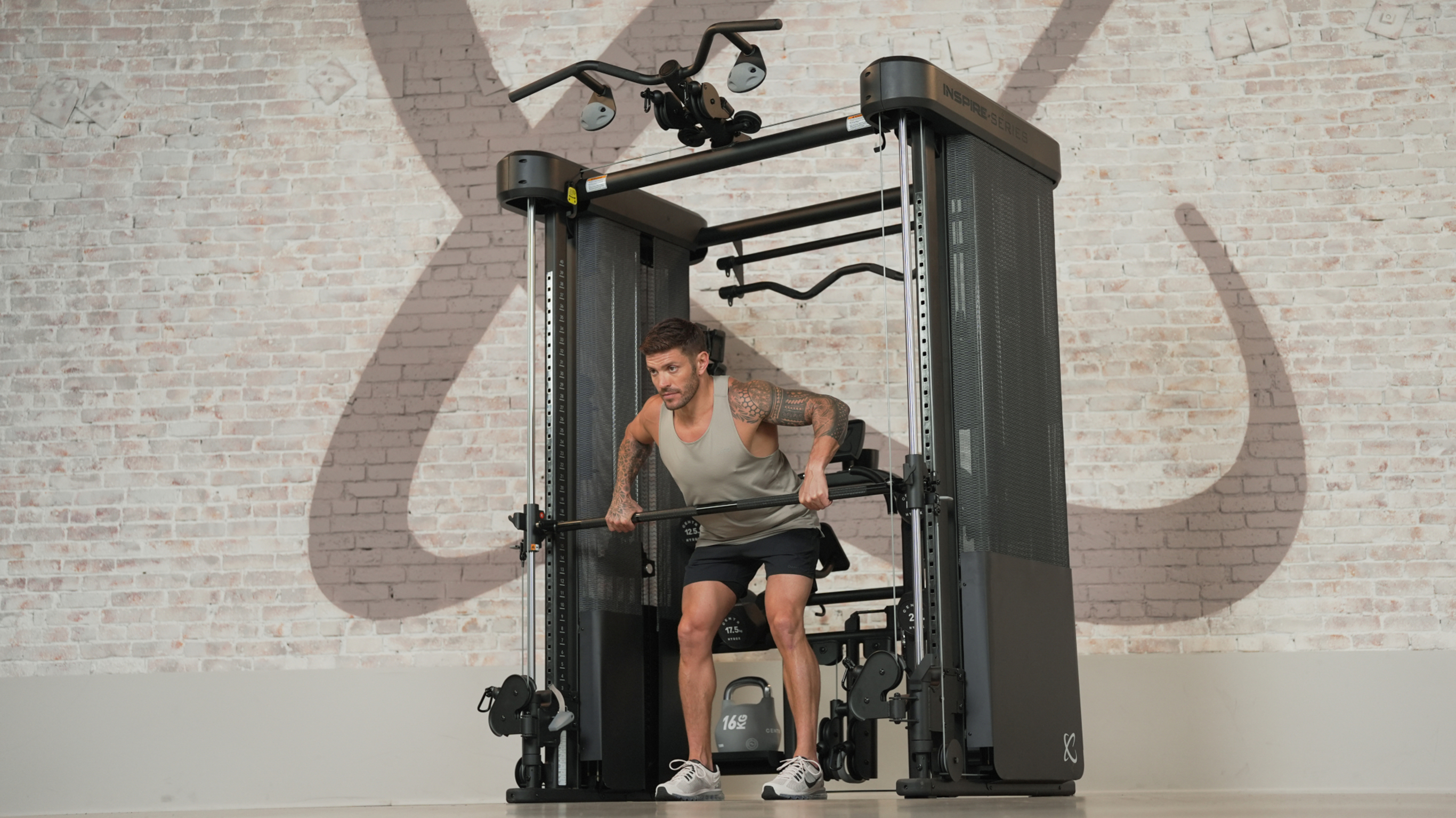 Luke Zocchi performs a bent over row on Centr's FT2Pro machine.