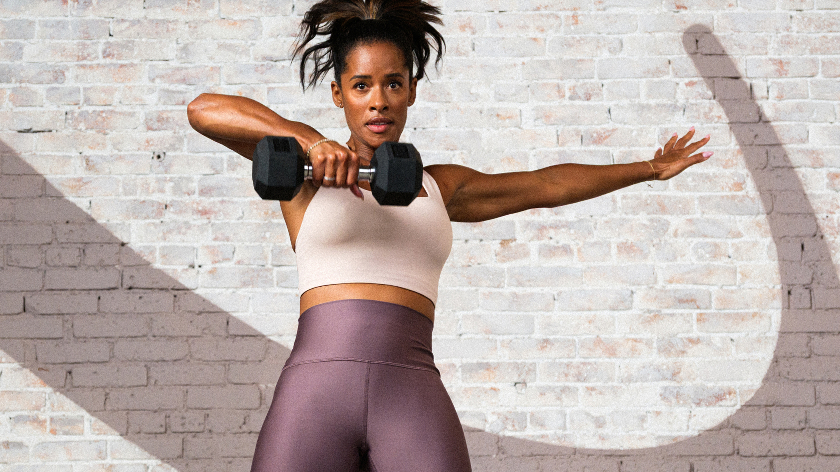 Ingrid Clay performs a single-arm upright row