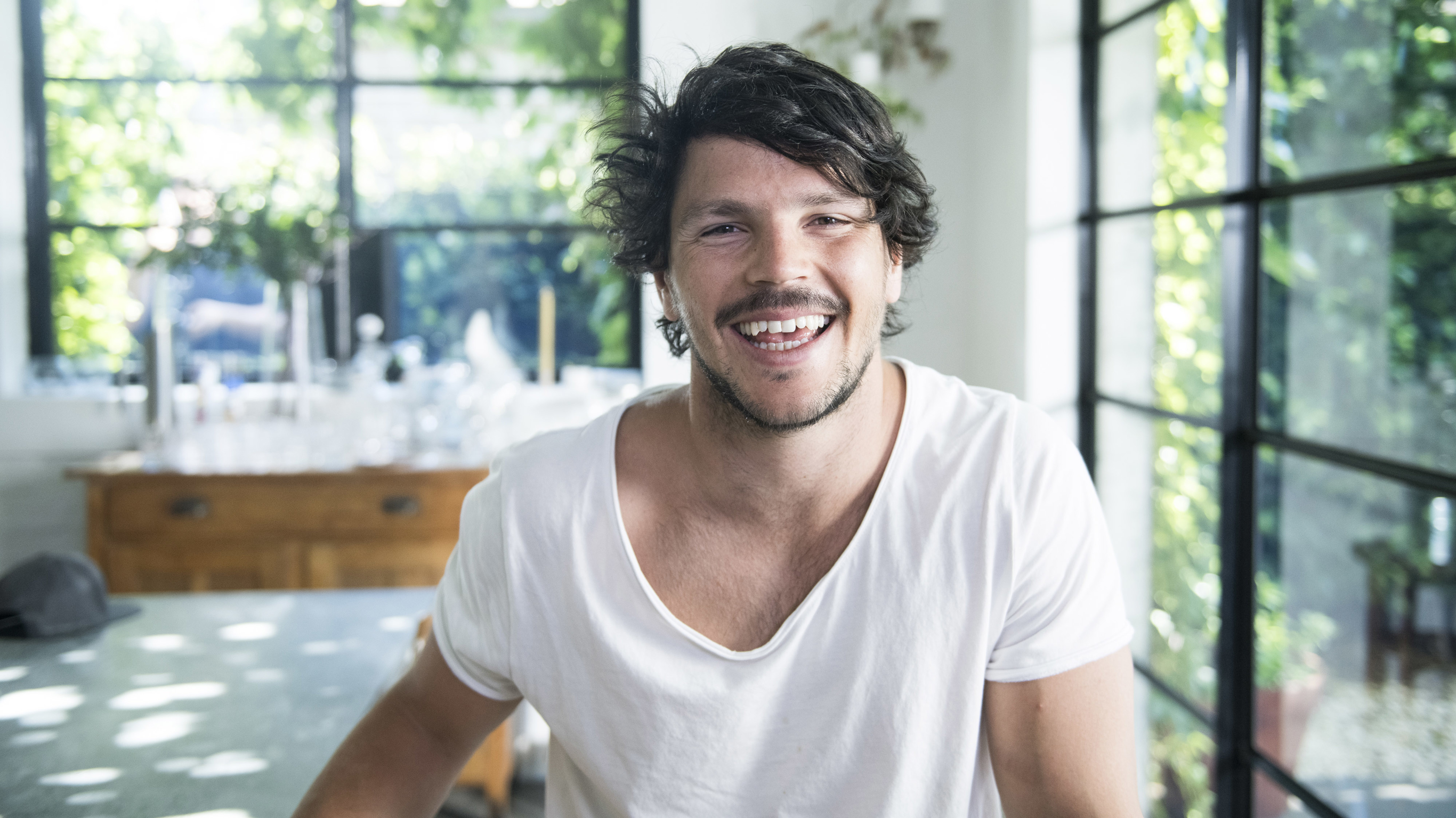 Dan Churchill in a sunlit room, smiling at the camera.