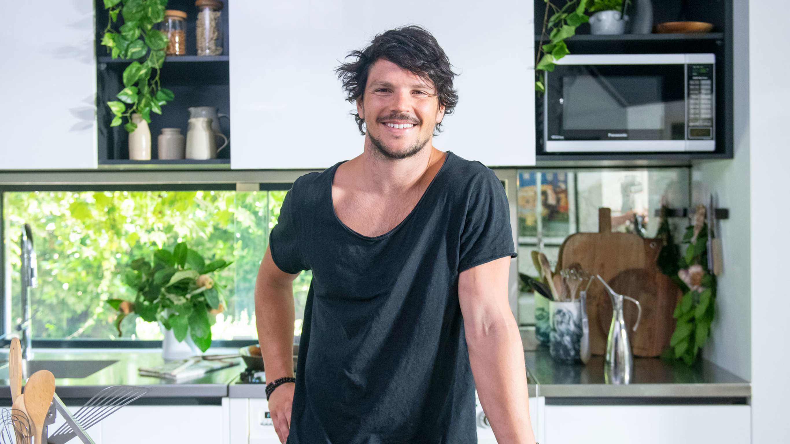 Dan Churchill smiling in the kitchen.