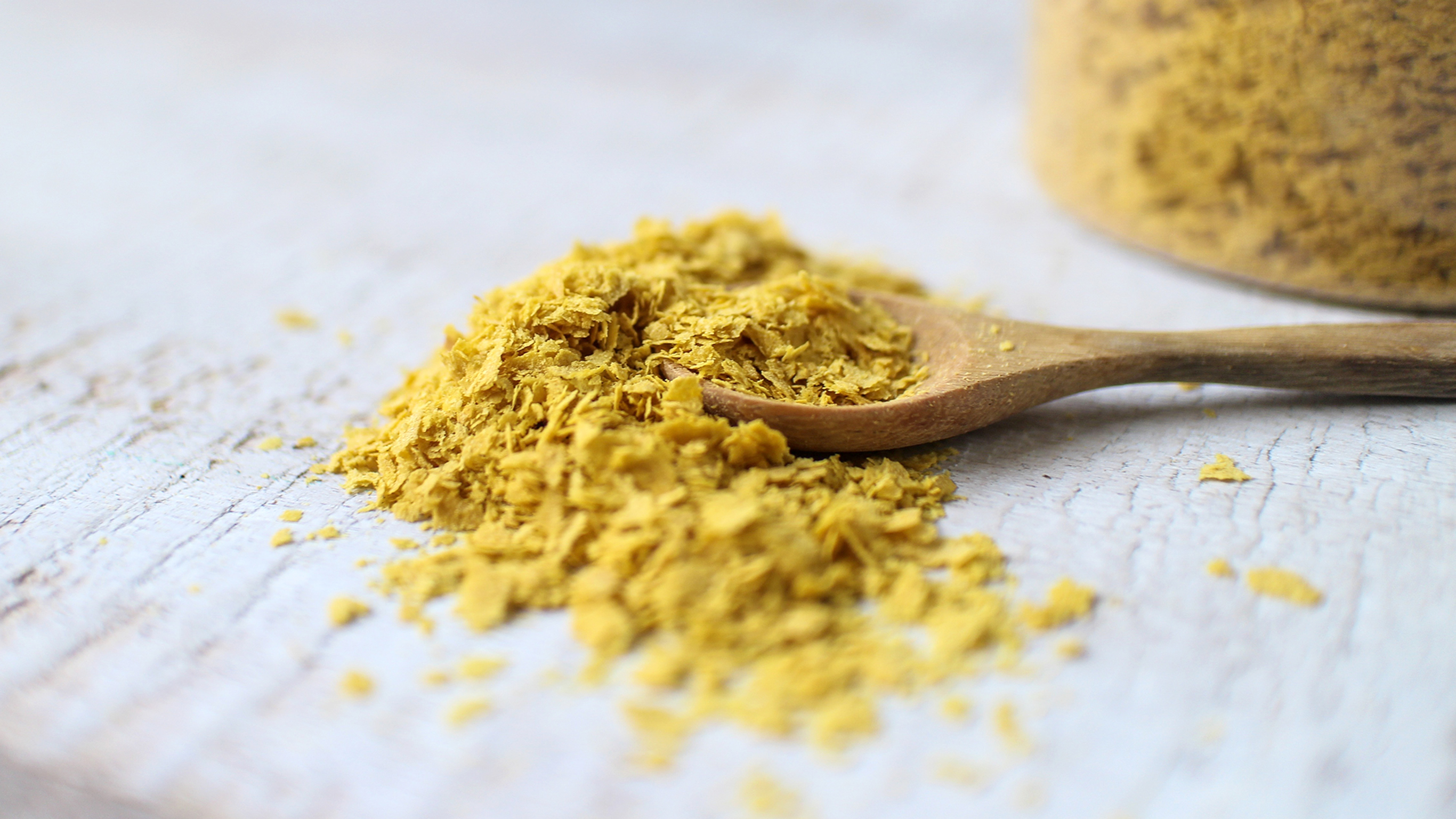 Nutritional yeast on a wooden spoon.
